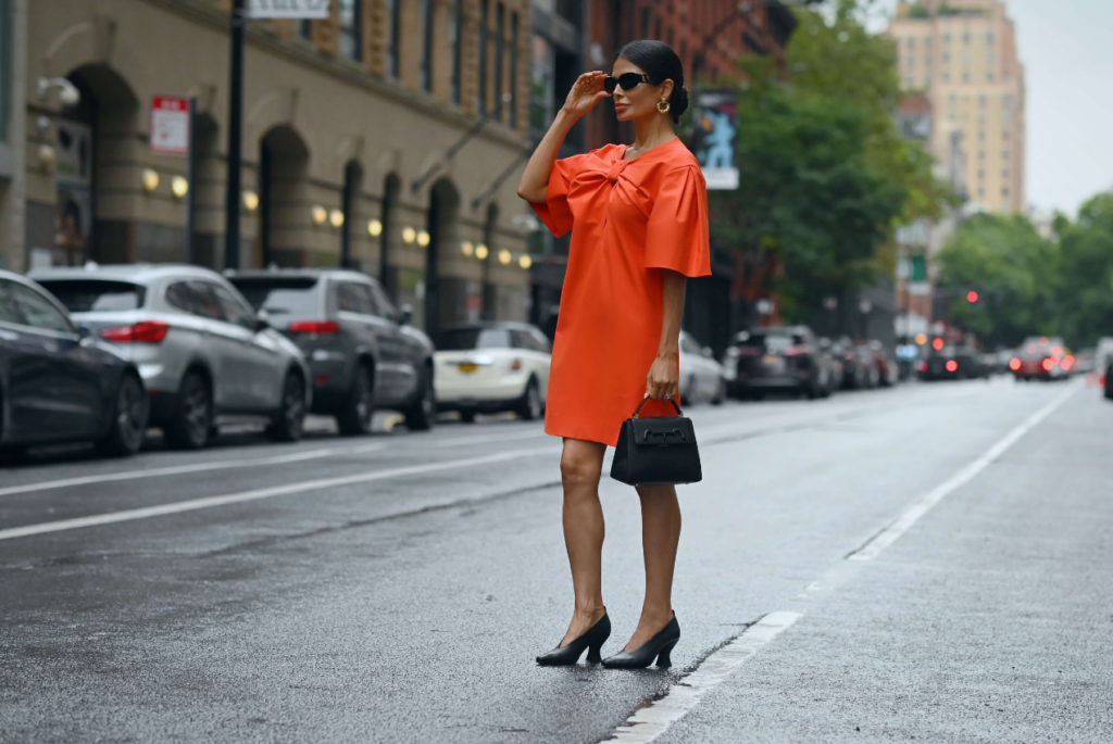 Victoria Barbara street style in red Carolina Herrera dress and Bottega Veneta shoes on her way to the Carolina Herrera Spring Summer 2022 Collection Runway Show during New York Fashion Week 2021