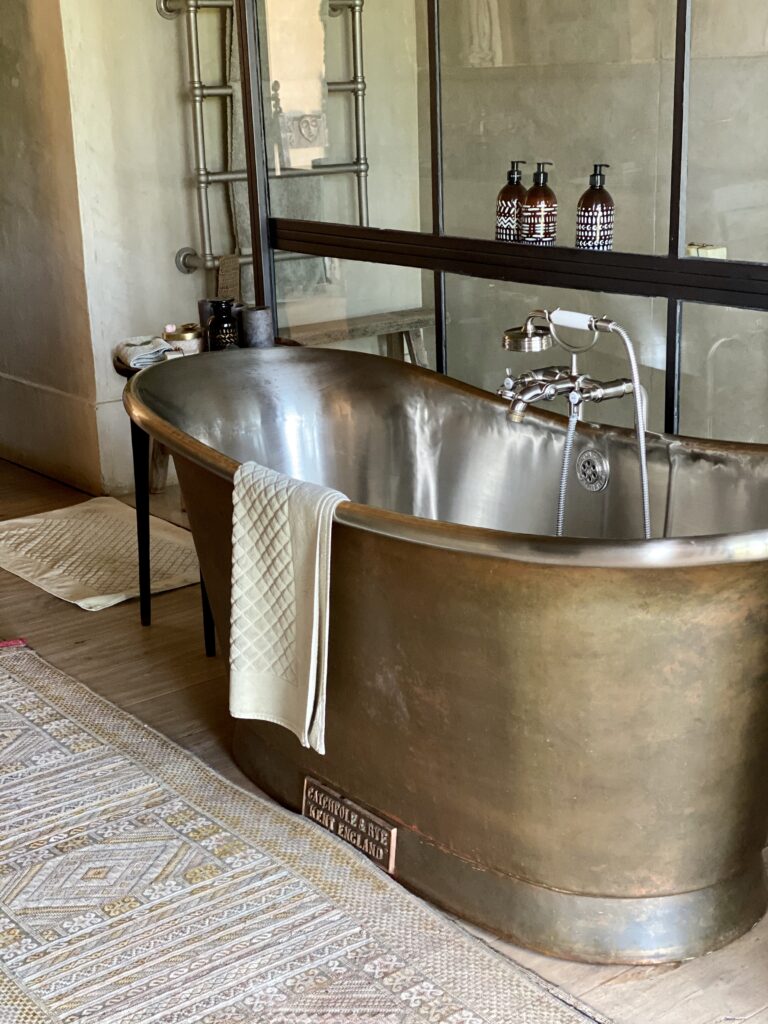 Freestanding metal bathtub luxury safari lodge Kenya interior detail