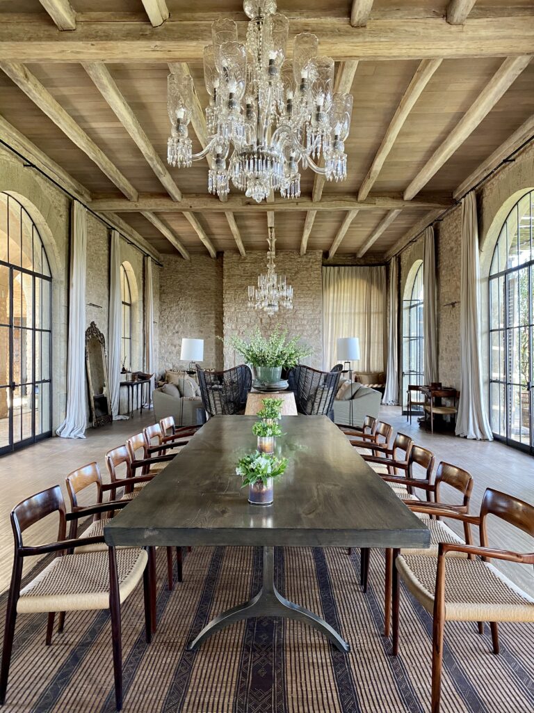 Luxury safari lodge dining and living room interior Arijiju Kenya with chandeliers and natural textures