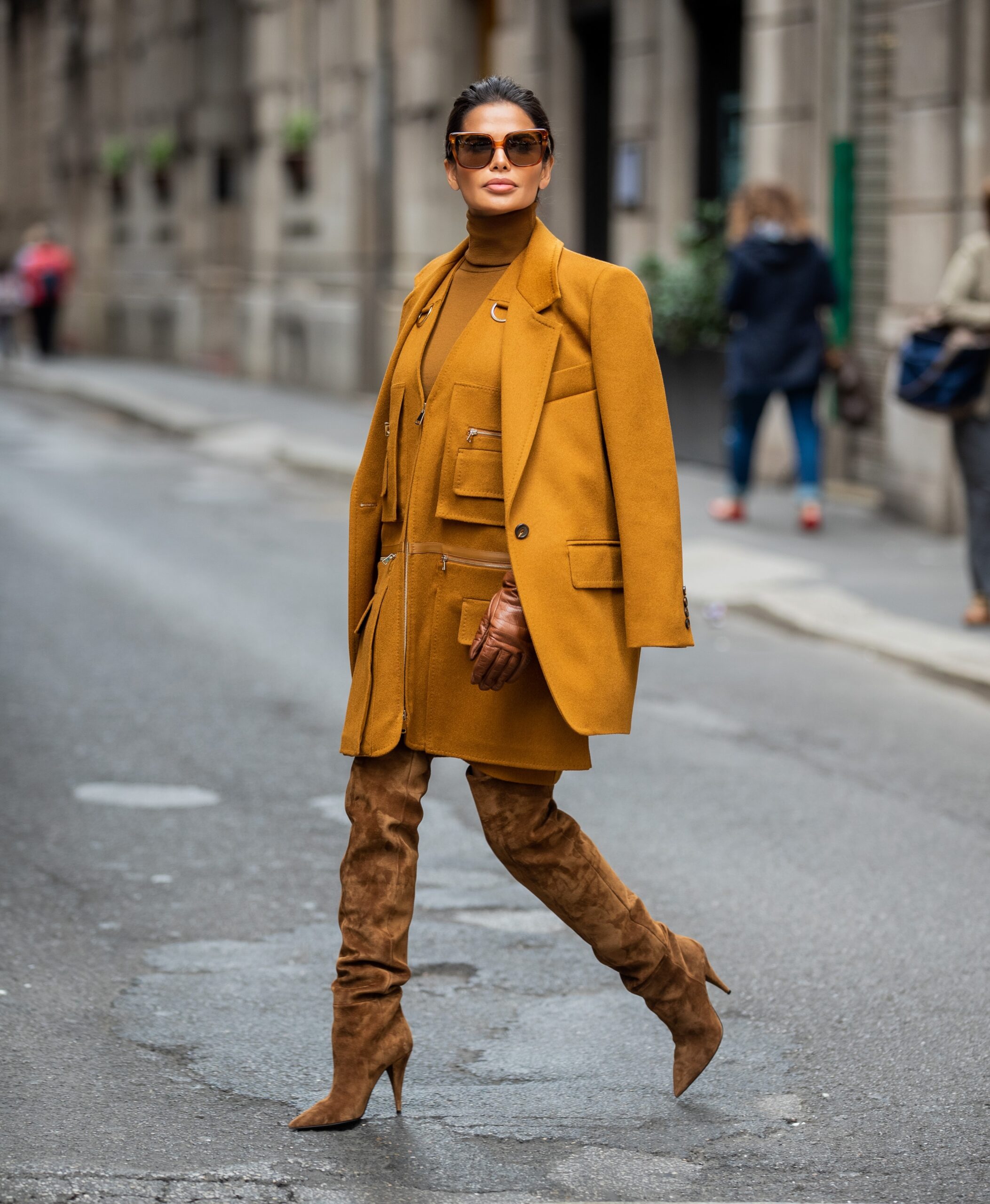 Victoria Barbara walking through Milan during Milan Fashion Week wearing a monochromatic Max Mara ensemble with Saint Laurent suede boots and Celine sunglasses.