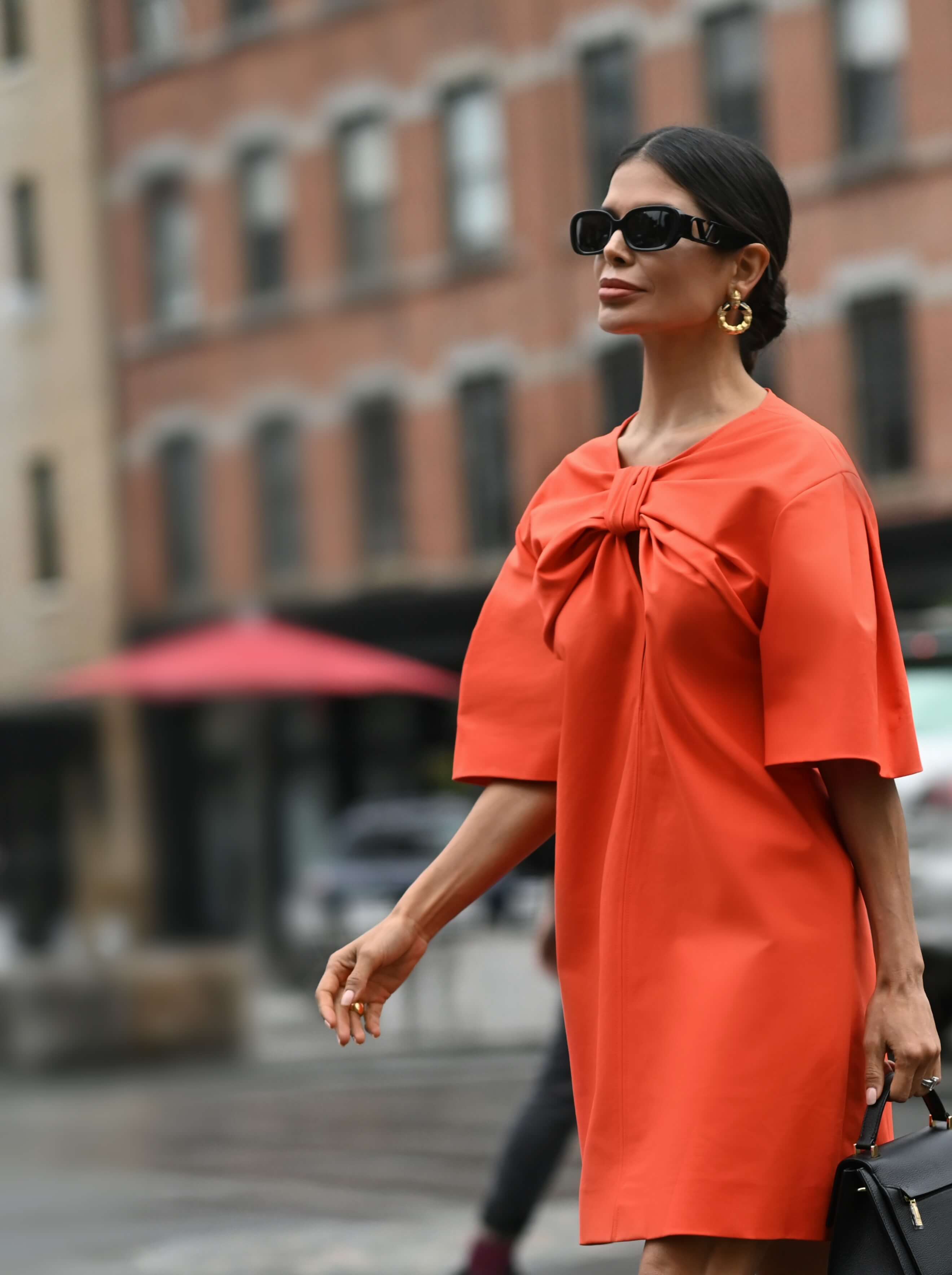 Victoria Barbara street style in red Carolina Herrera dress and Bottega Veneta shoes on her way to the Carolina Herrera Spring Summer 2022 Collection Runway Show during New York Fashion Week 2021