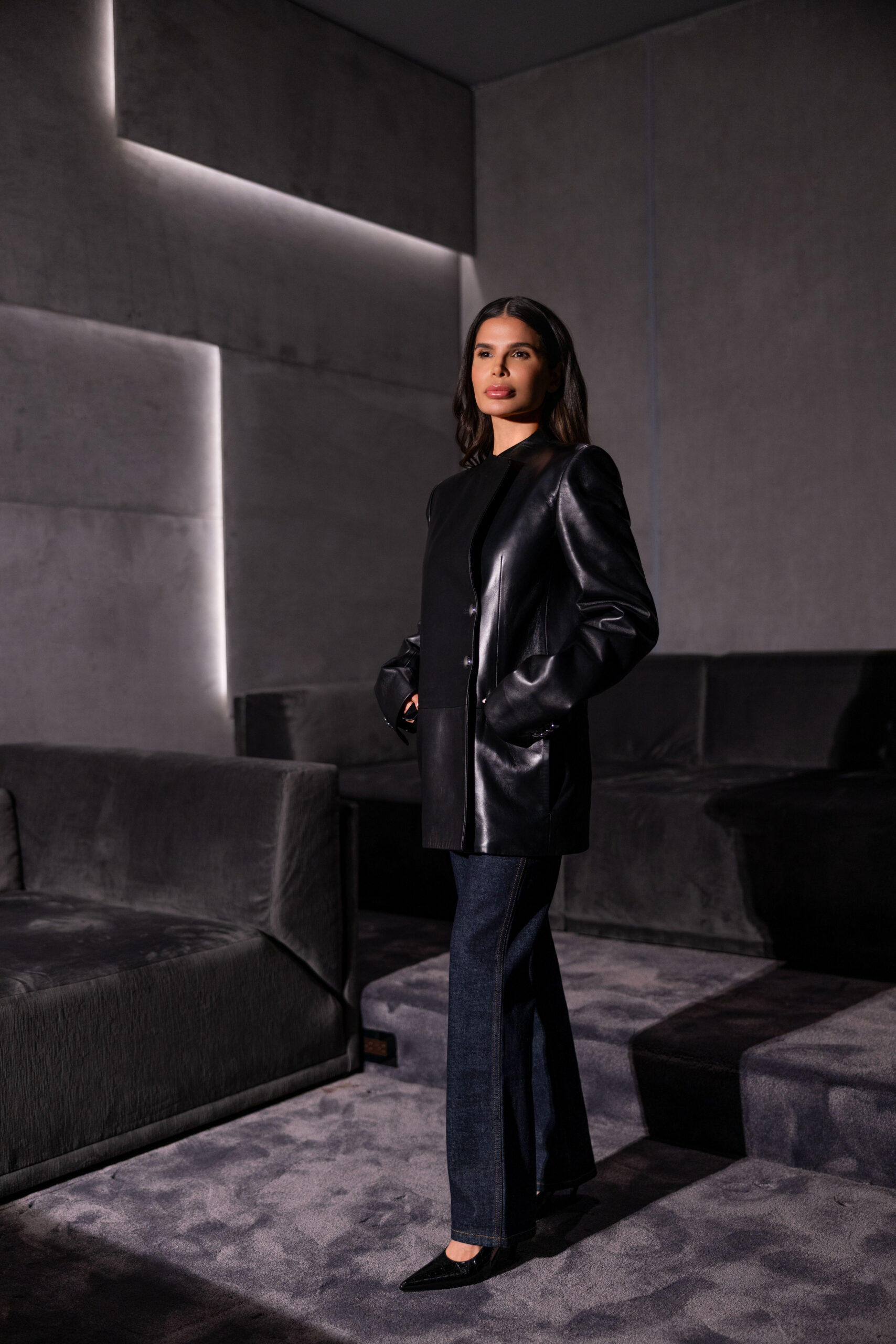 Victoria Barbara wearing Khaite black structured leather jacket and tailored pants in minimalist editorial setting
