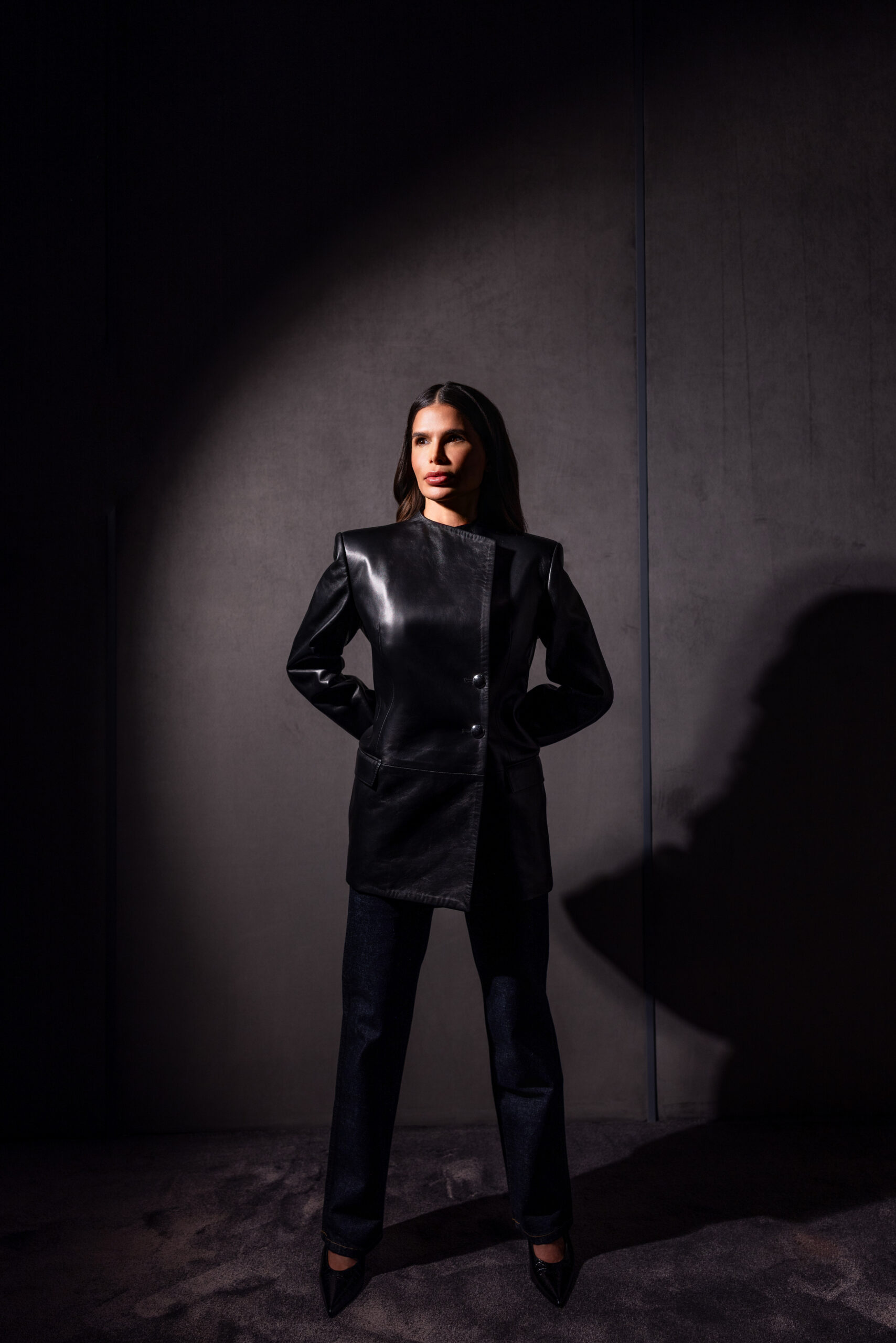 Victoria Barbara wearing Khaite black structured leather jacket and tailored pants in editorial studio lighting