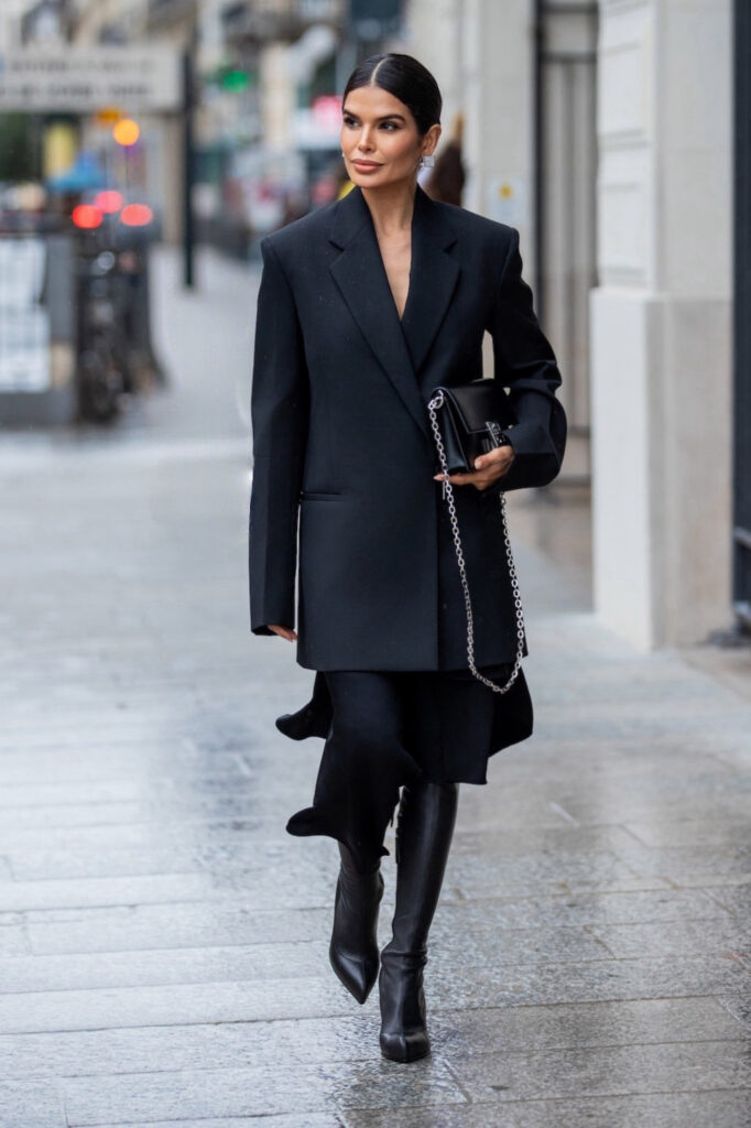 Victoria Barbara wearing a black Givenchy blazer and skirt with boots walking in Paris during Fashion Week
