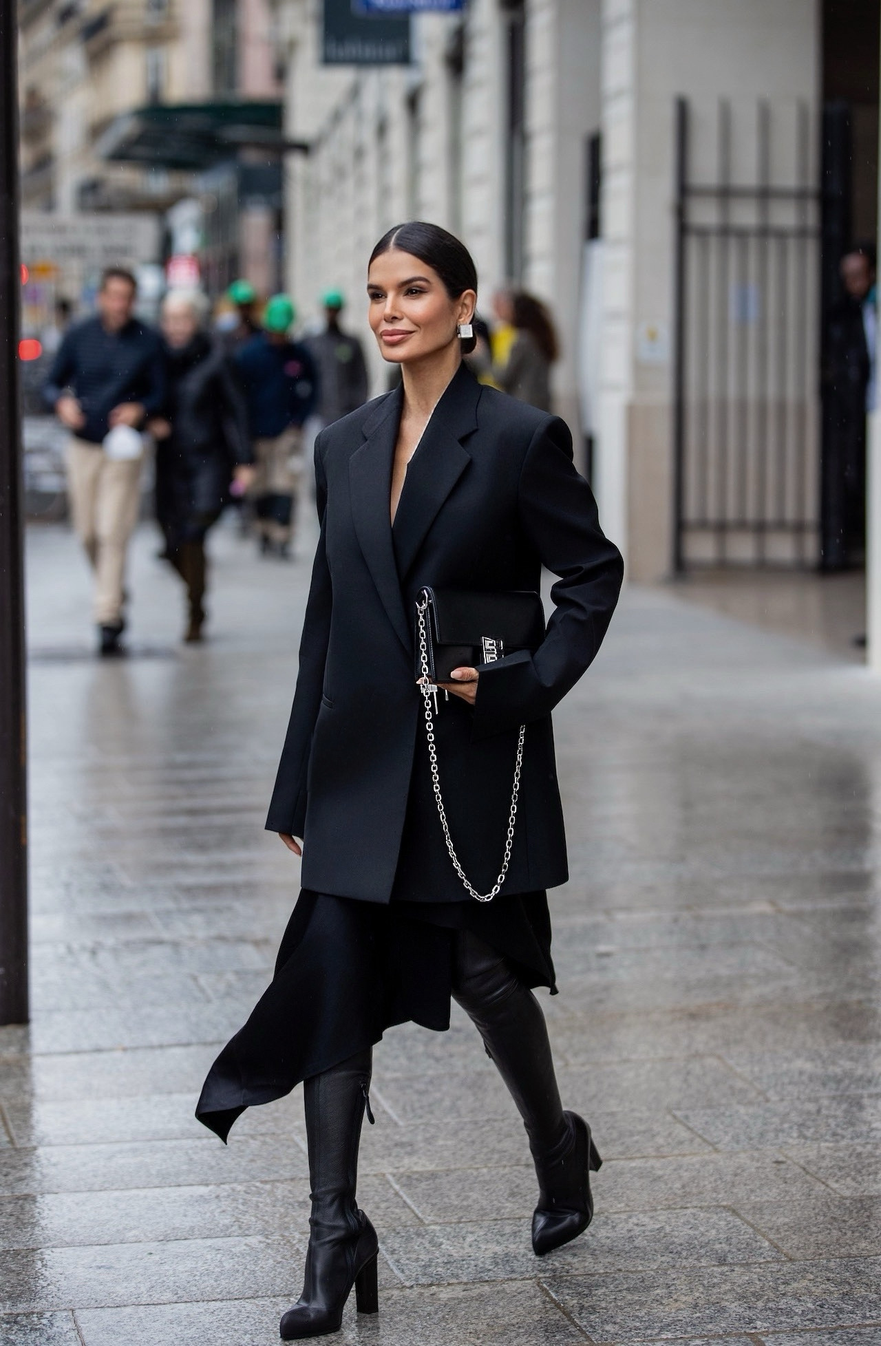Victoria Barbara walking in Paris wearing structured black Givenchy tailoring with heels and handbag