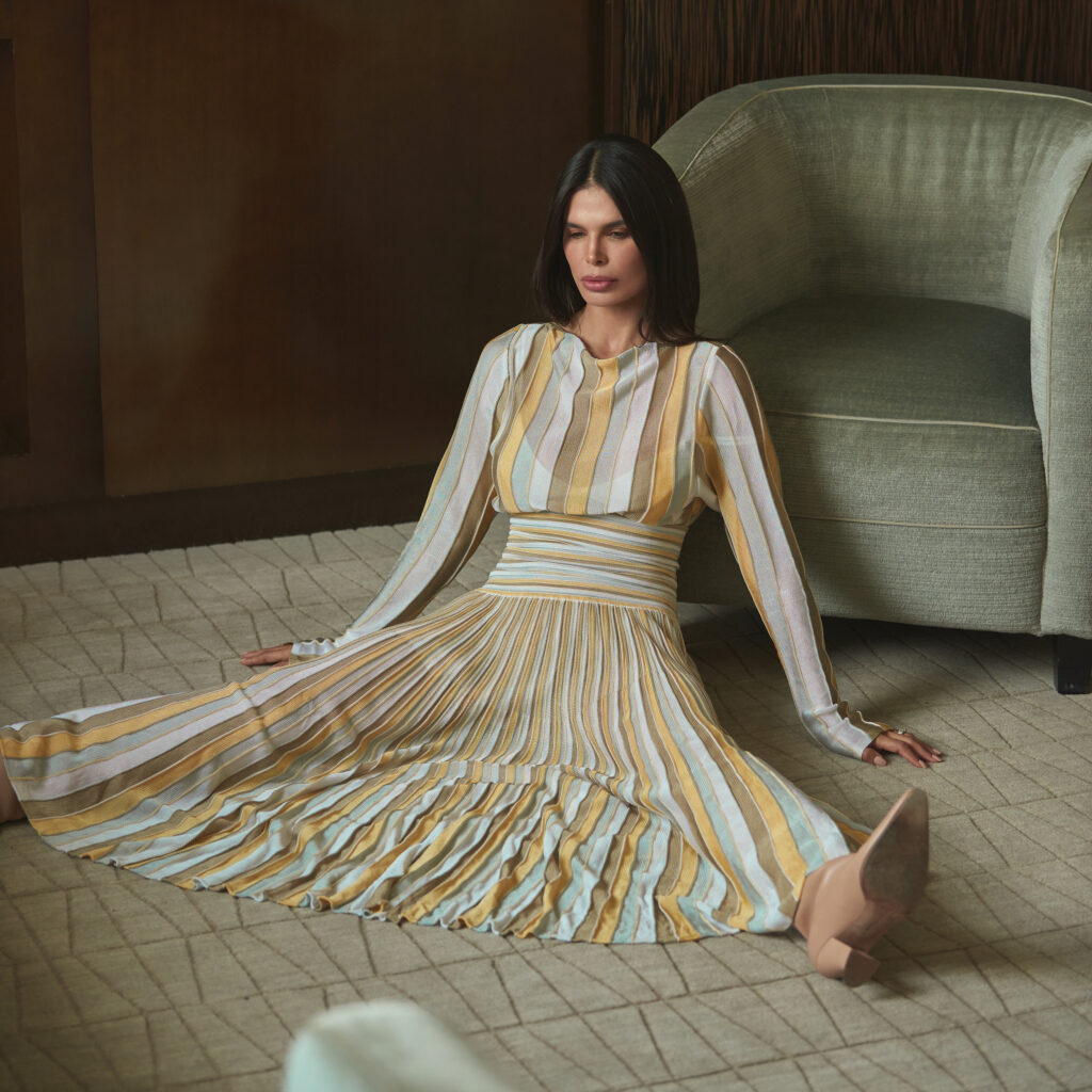 Bevza pleated dress in soft neutral tones styled in interior setting with structured silhouette