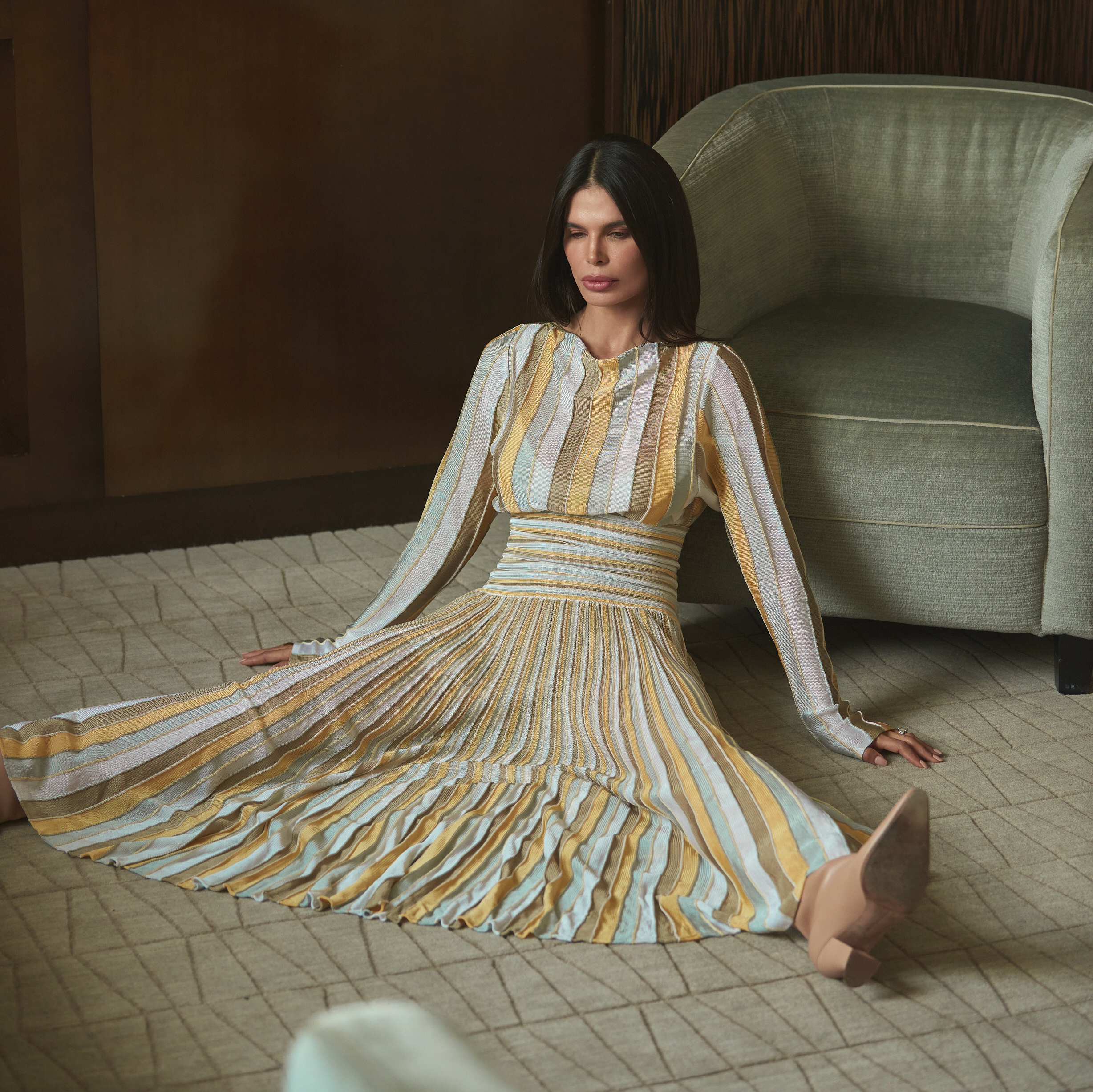 Bevza pleated dress in soft neutral tones styled in interior setting with structured silhouette