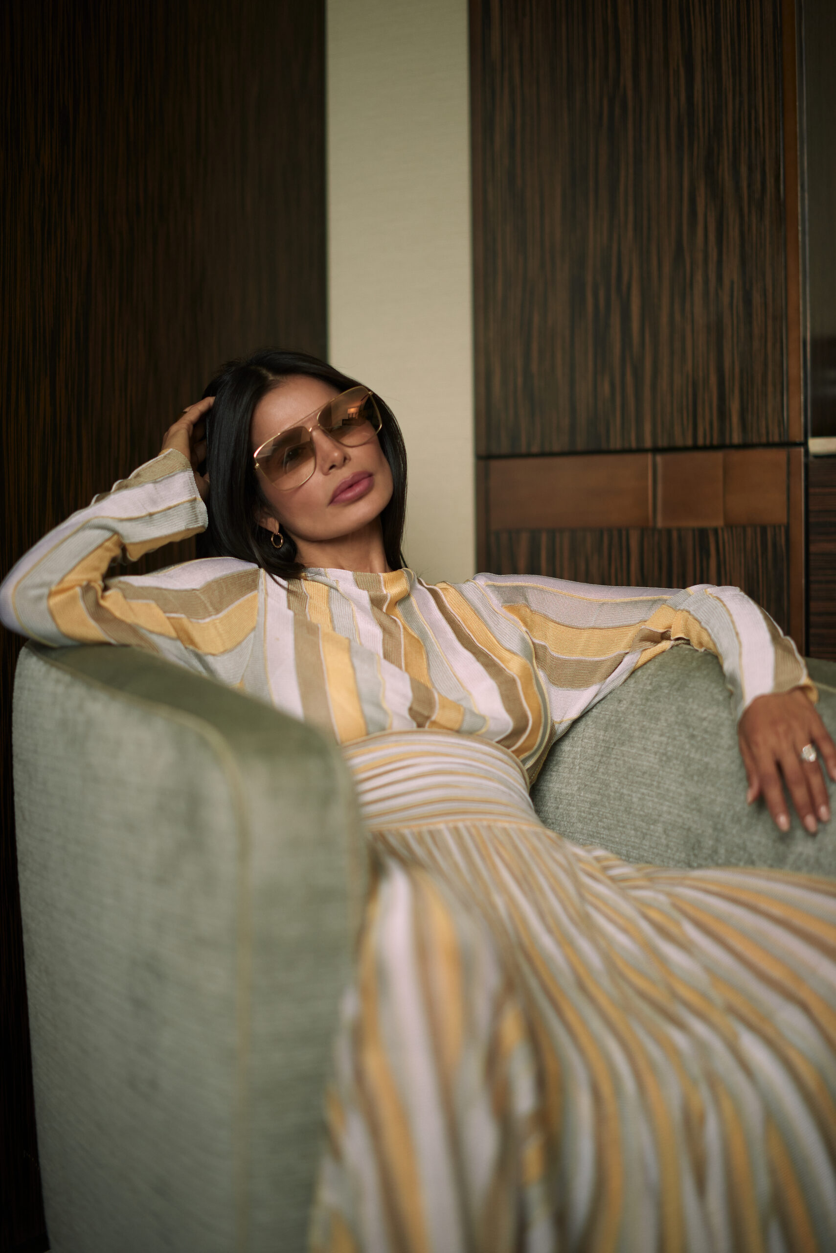 Relaxed seated pose wearing Bevza dress with modern accessories and structured silhouette