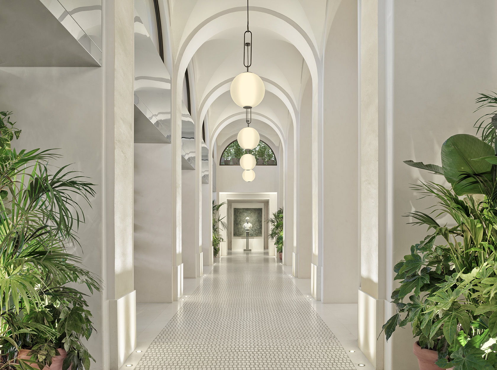 Arched corridor at The Lake Como EDITION with marble columns and soft lighting
