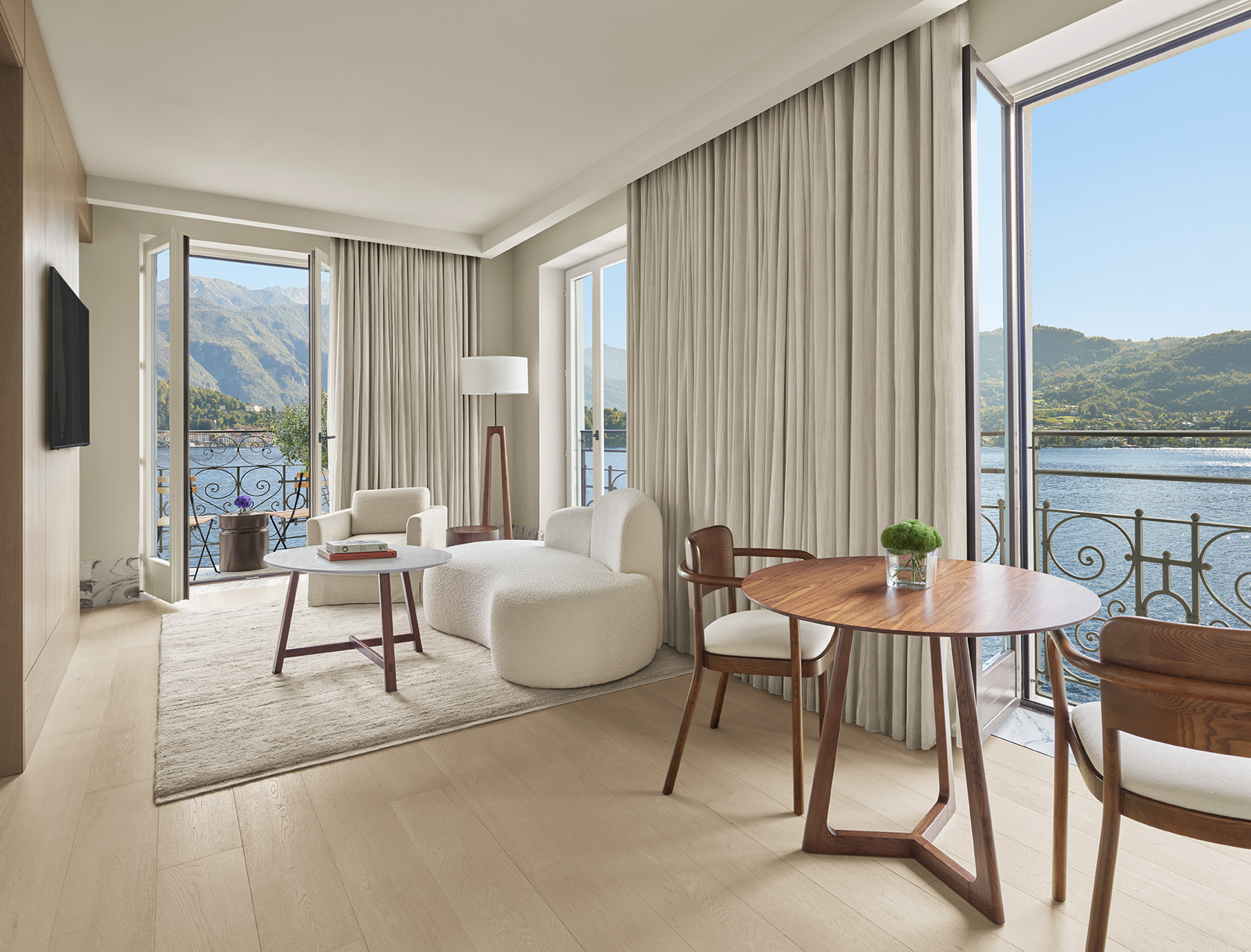 Suite interior at The Lake Como EDITION with lake view terrace and neutral design