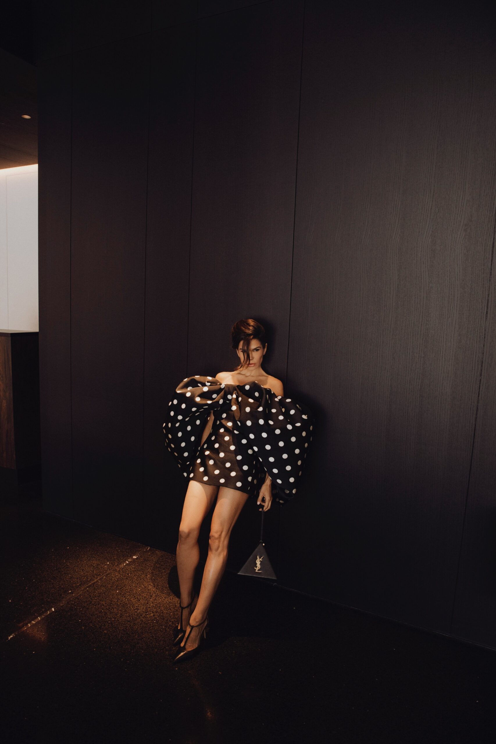 Full body Givenchy polka dot dress showing sculpted silhouette against minimal background