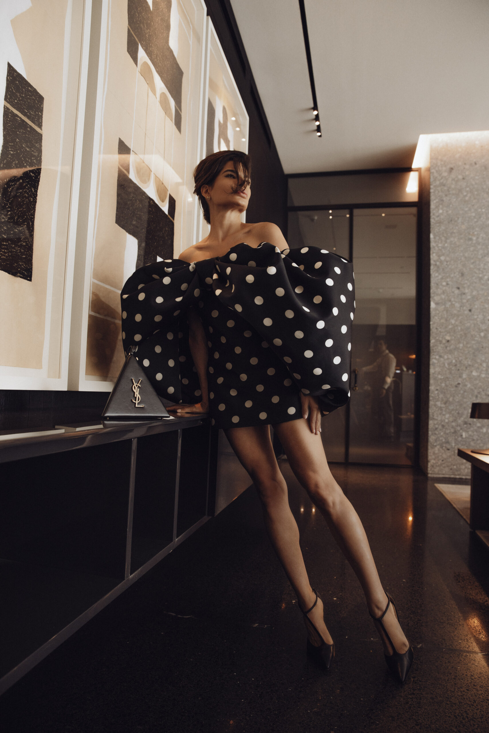 Givenchy look styled with Saint Laurent leather bag in interior setting