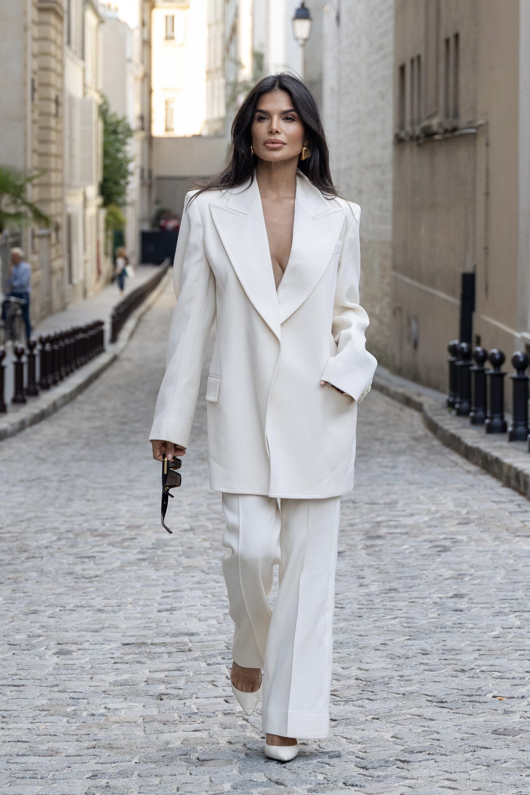 Victoria Barbara wearing a white Givenchy tailored suit walking in Paris during Haute Couture