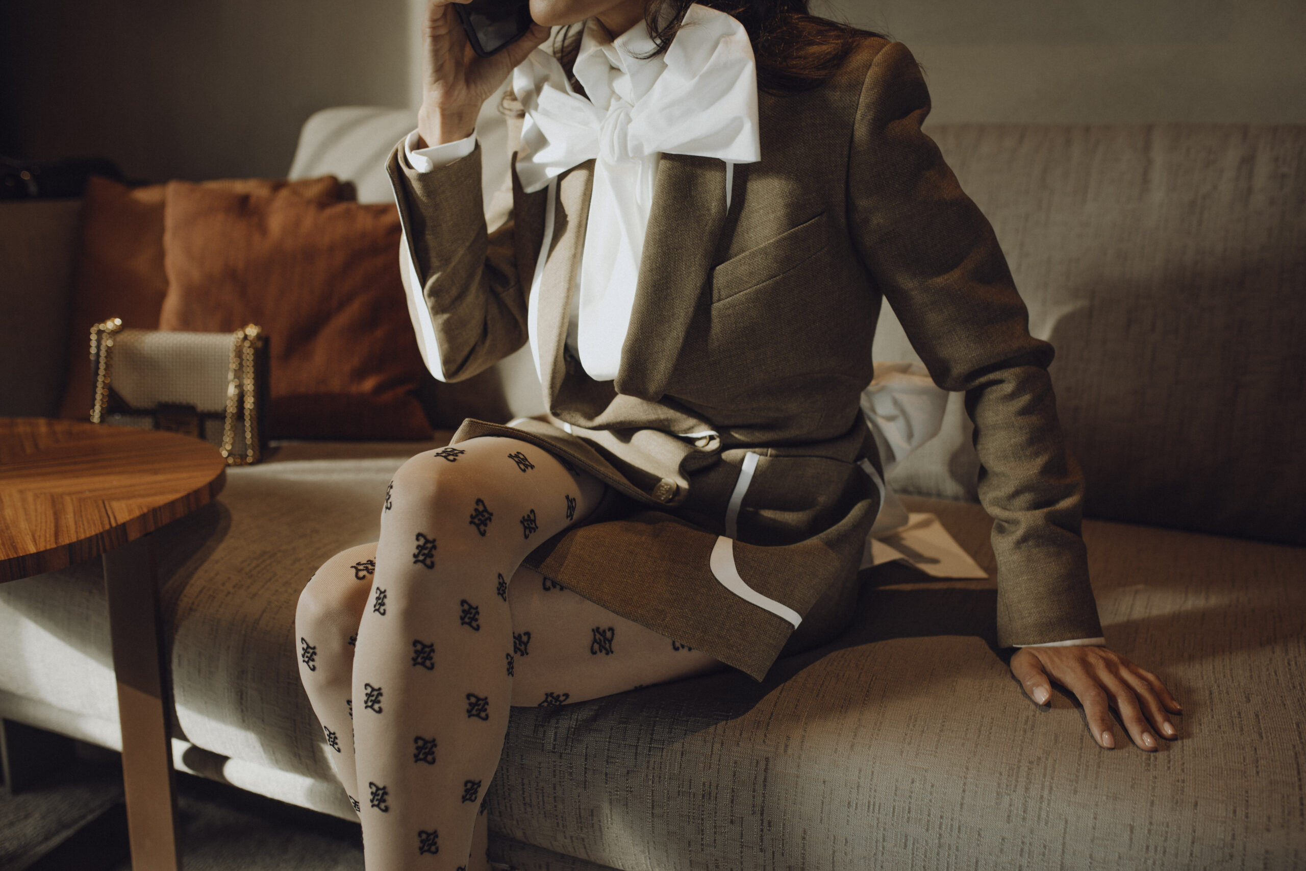 Detail of Fendi look showing patterned tights, tailored skirt, and refined textures in editorial styling