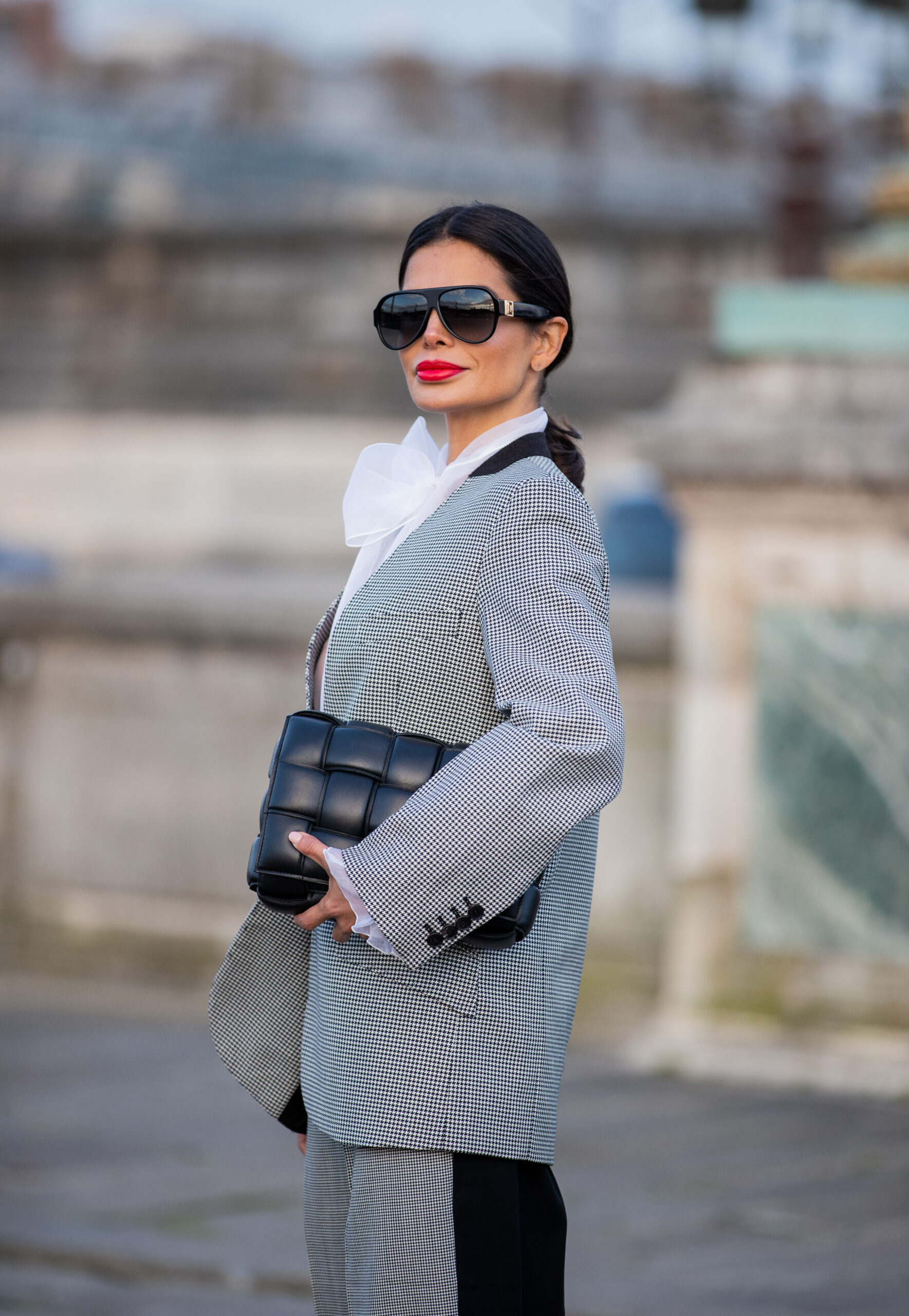 Victoria Barbara walking in Givenchy tailoring with contrast stripe trousers during Paris Fashion Week