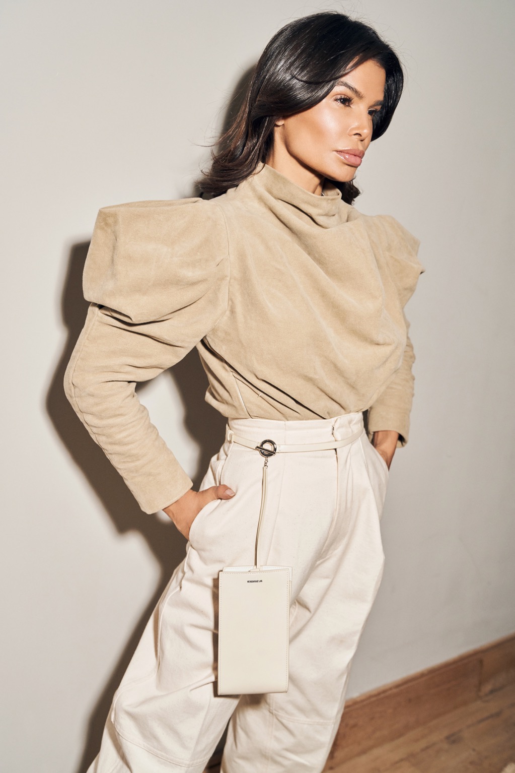 Victoria Barbara wearing a structured neutral Isabel Marant look with belted waist and Louis Vuitton boots in an editorial setting