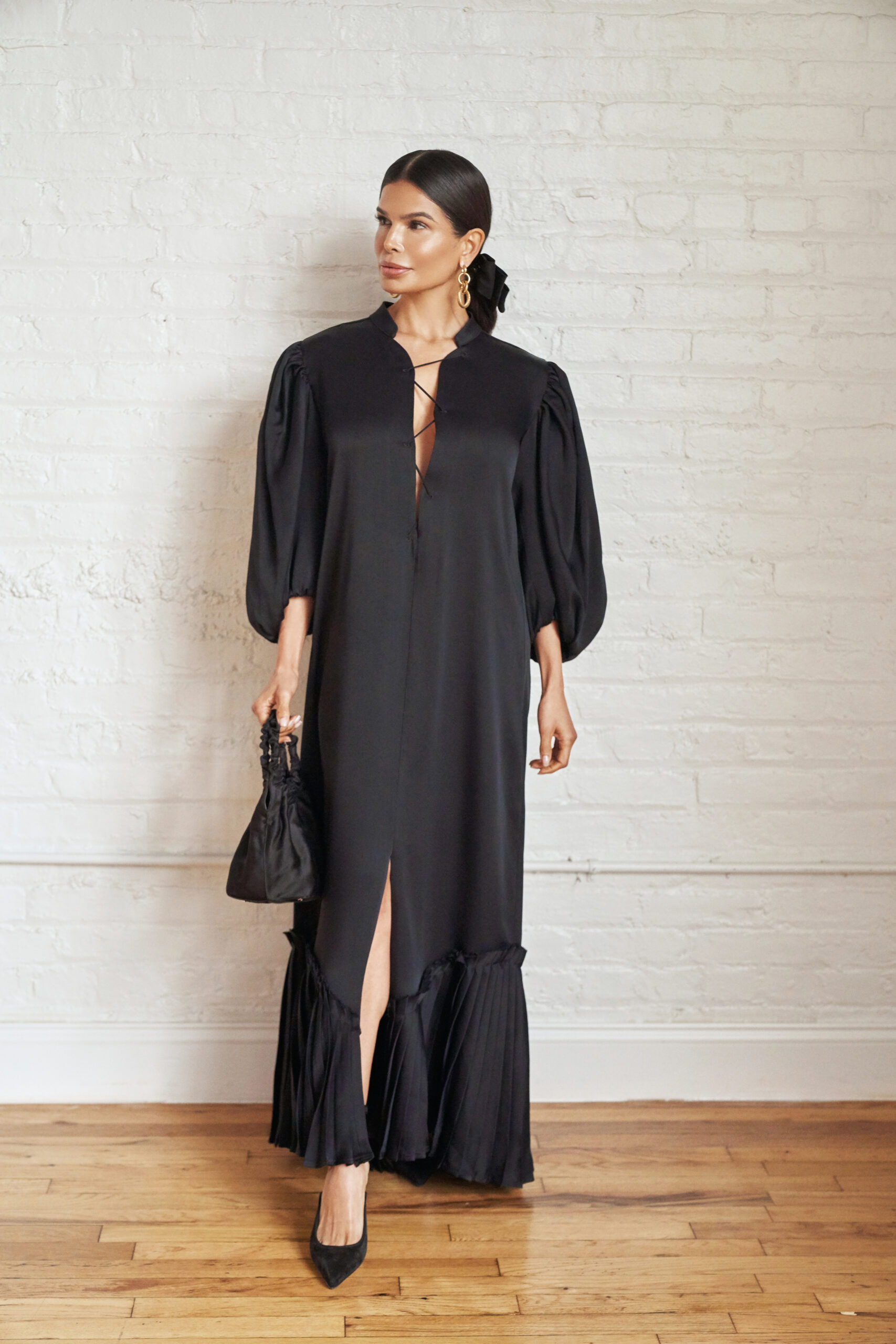 Victoria Barbara wearing a black Khaite dress with structured silhouette in a minimal editorial setting