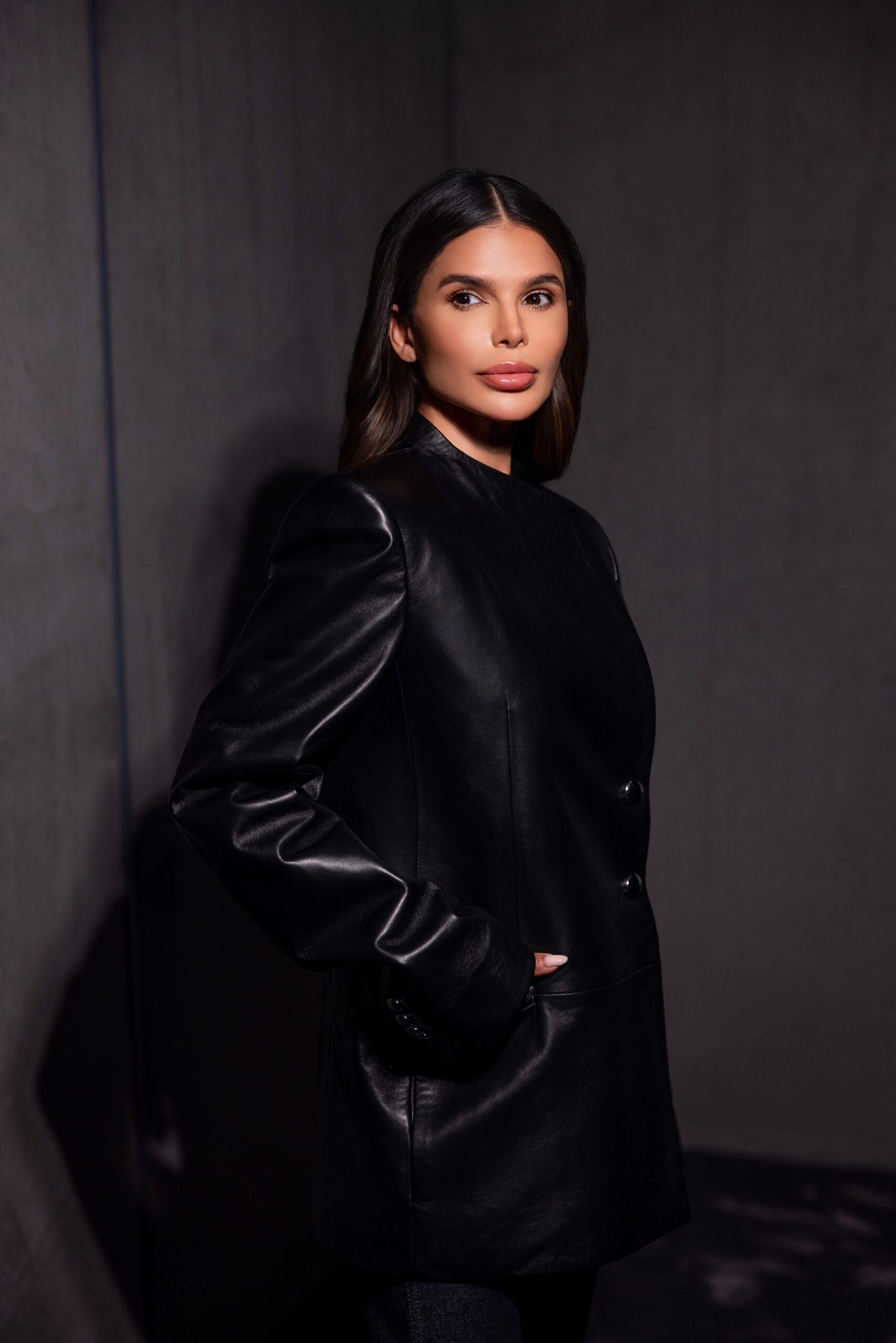 Khaite black leather blazer close-up portrait, natural skin finish and sleek hair with focus on texture and craftsmanship