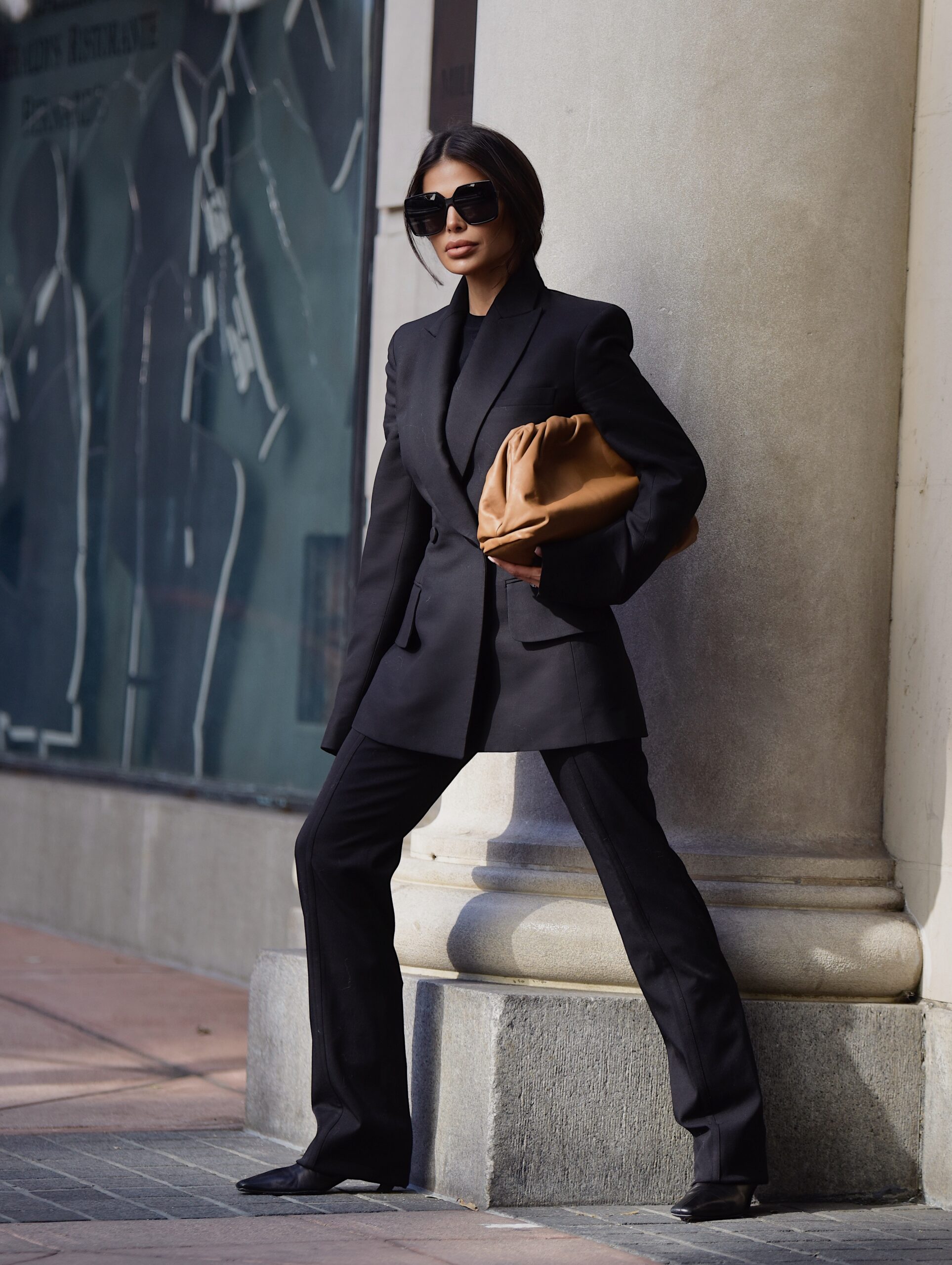Victoria Barbara wearing Khaite suit with Max Mara coat and Bottega Veneta pouch during New York Fashion Week