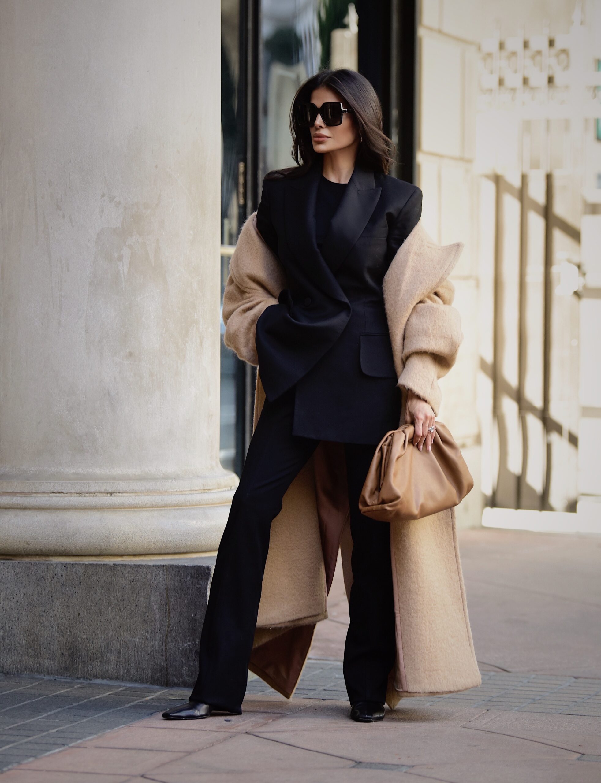 Victoria Barbara wearing structured Khaite blazer and trousers with Bottega Veneta pouch bag