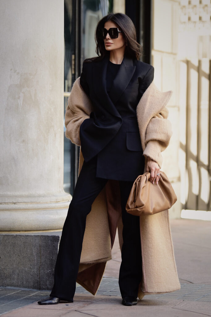 Victoria Barbara wearing structured Khaite blazer and trousers with Bottega Veneta pouch bag