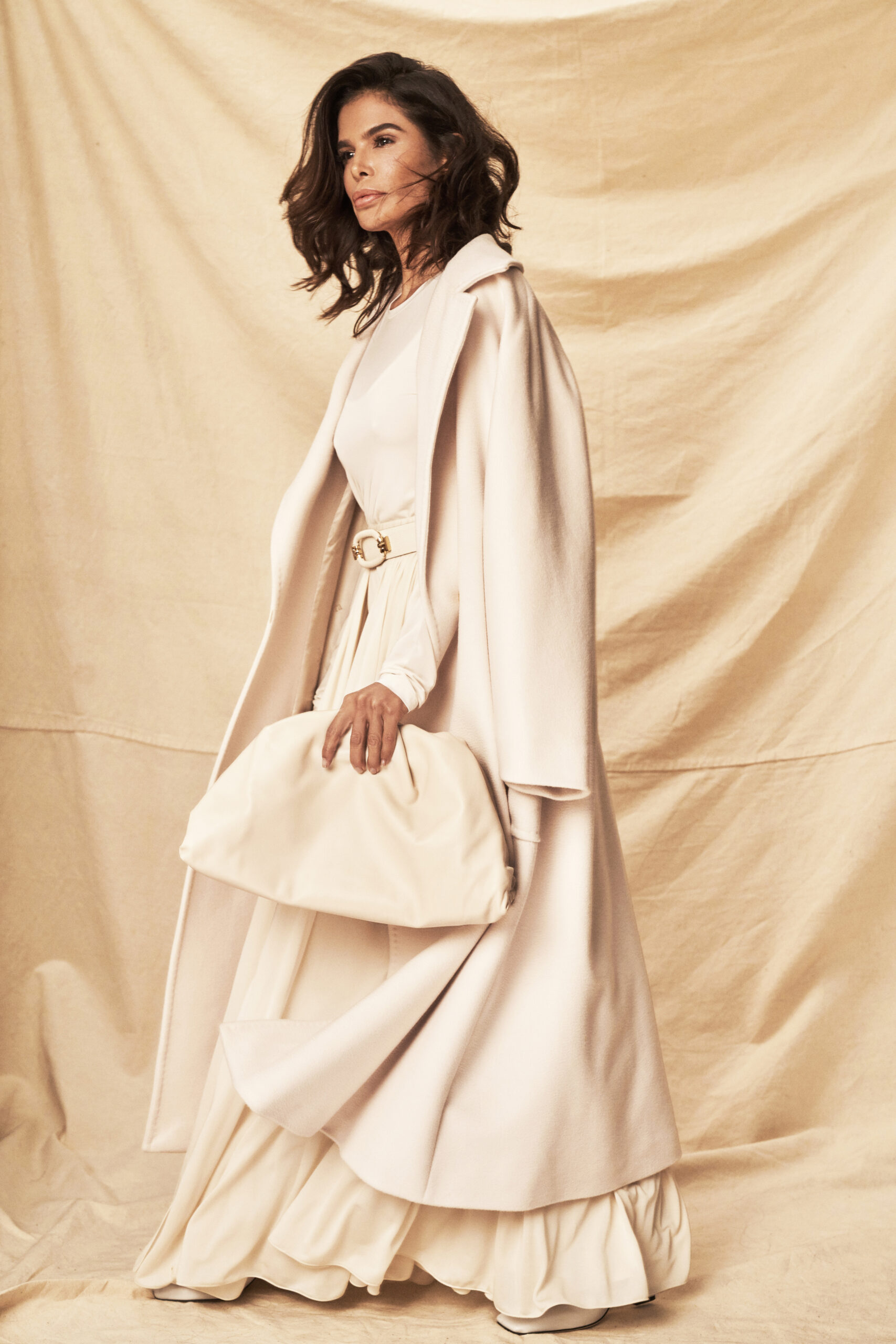 Victoria Barbara wearing a monochrome Max Mara look with long coat and neutral palette in an editorial setting