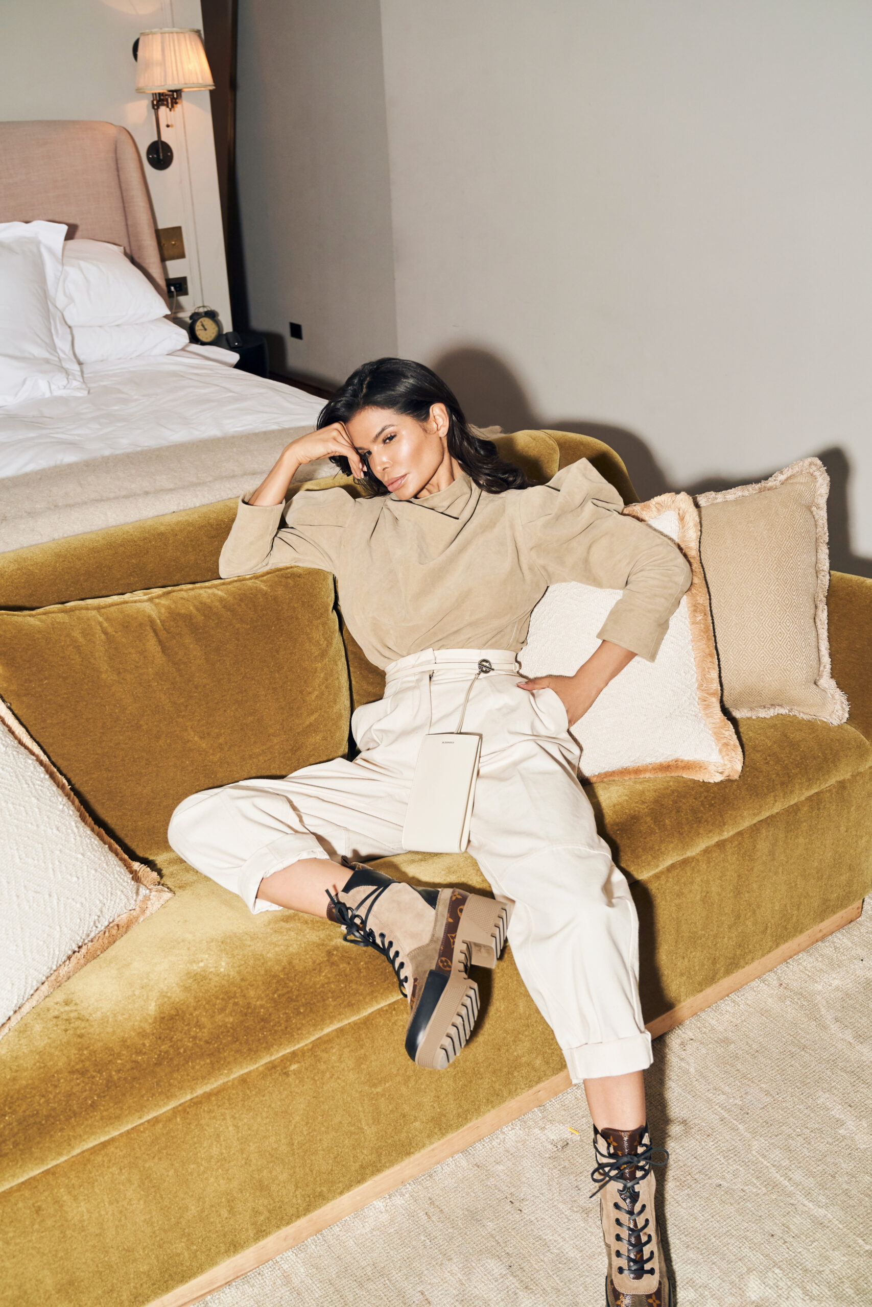 Victoria Barbara seated in Soho House New York suite wearing neutral-toned outfit