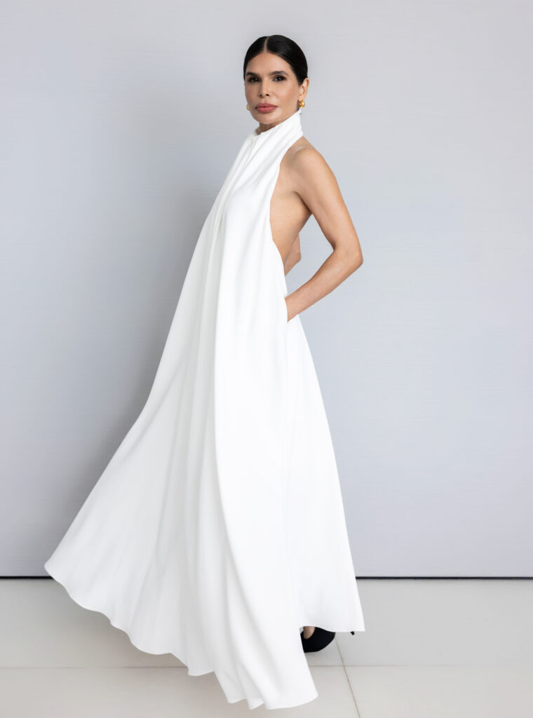 Victoria Barbara wearing a long white Givenchy dress in an editorial studio setting with structured silhouette