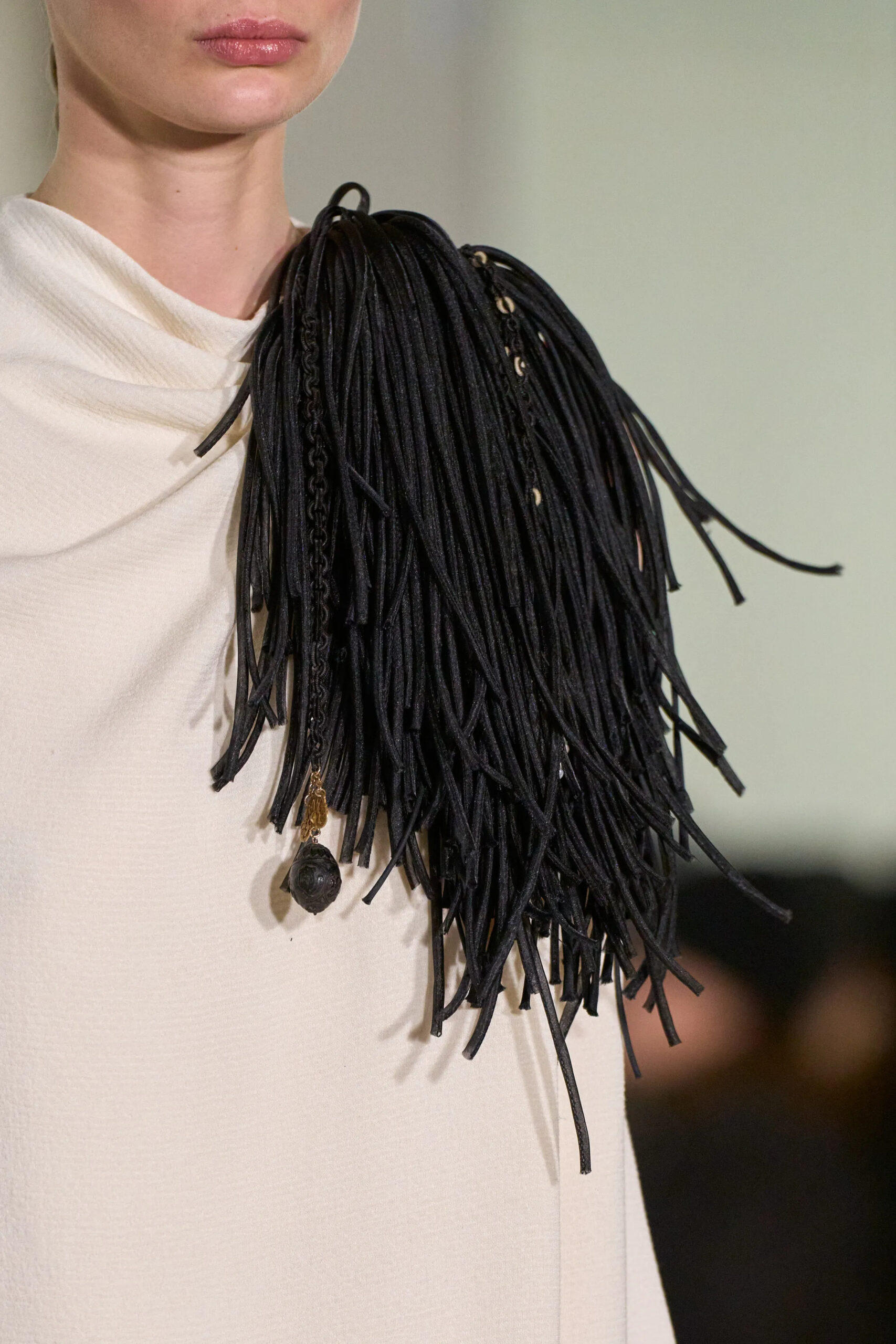 Close-up of black leather fringe shoulder detail at Altuzarra Fall Winter 2026