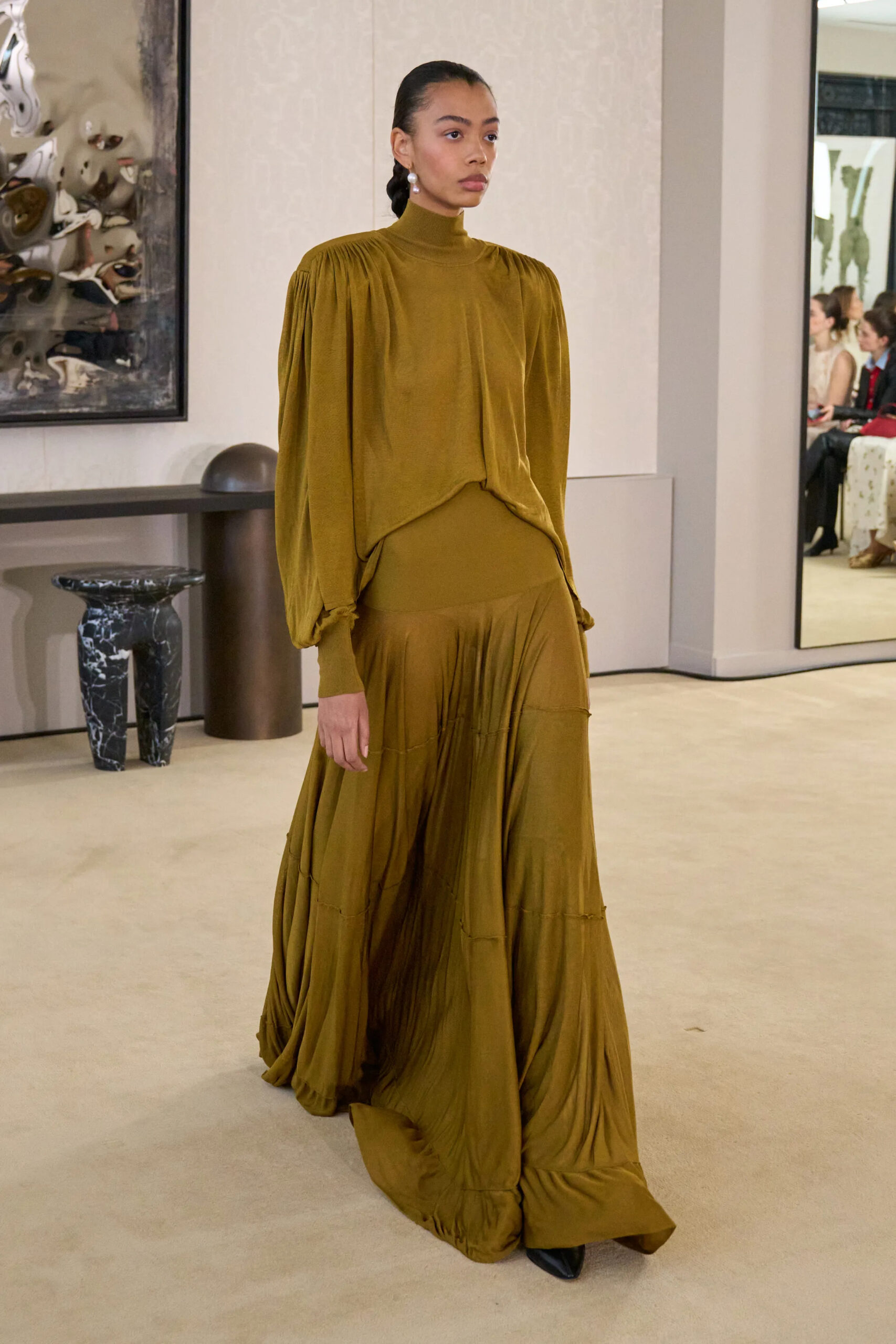 Model wearing an olive draped jersey gown with gathered detailing at Altuzarra Fall Winter 2026
