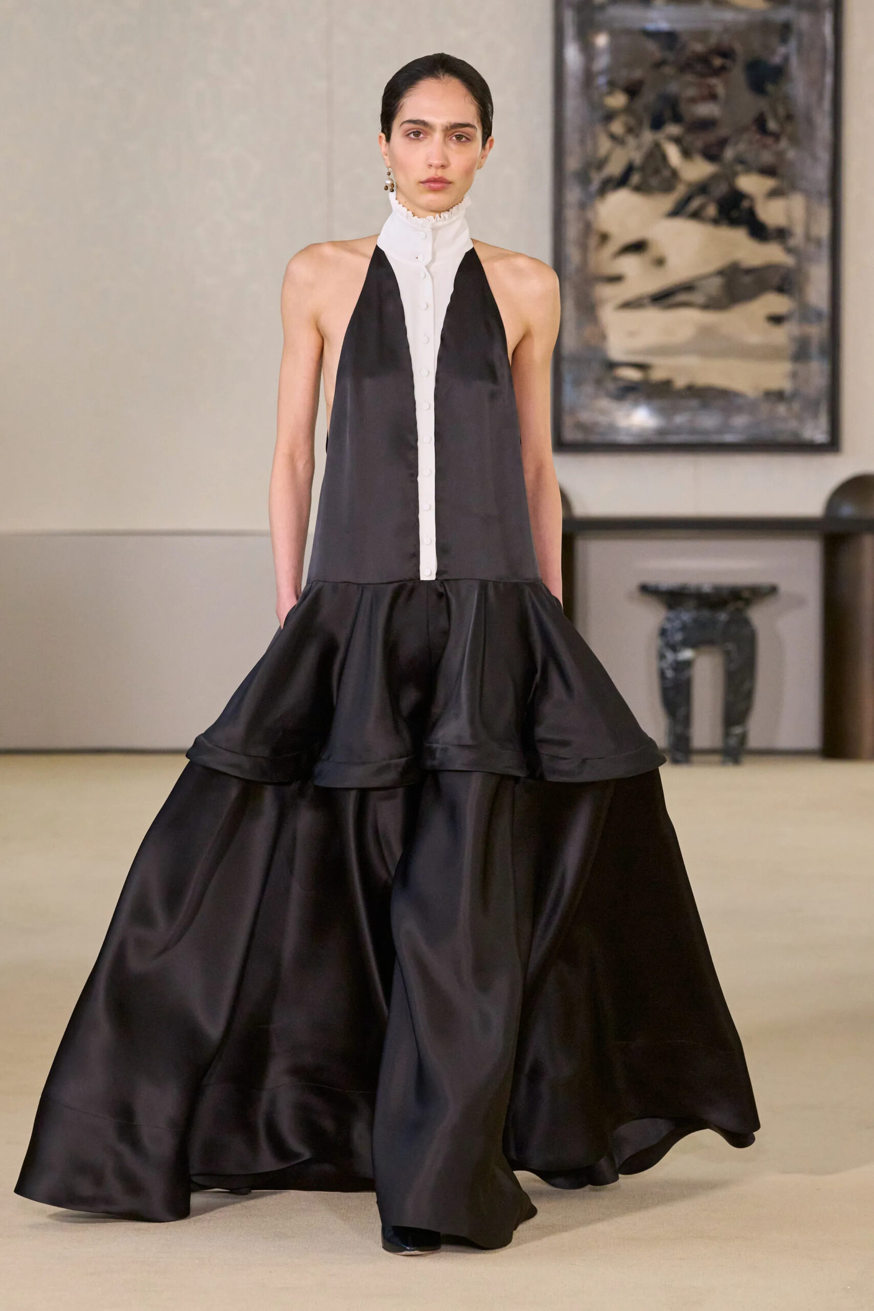 Model wearing a black-and-ivory halter evening gown with sculptural volume at Altuzarra Fall Winter 2026