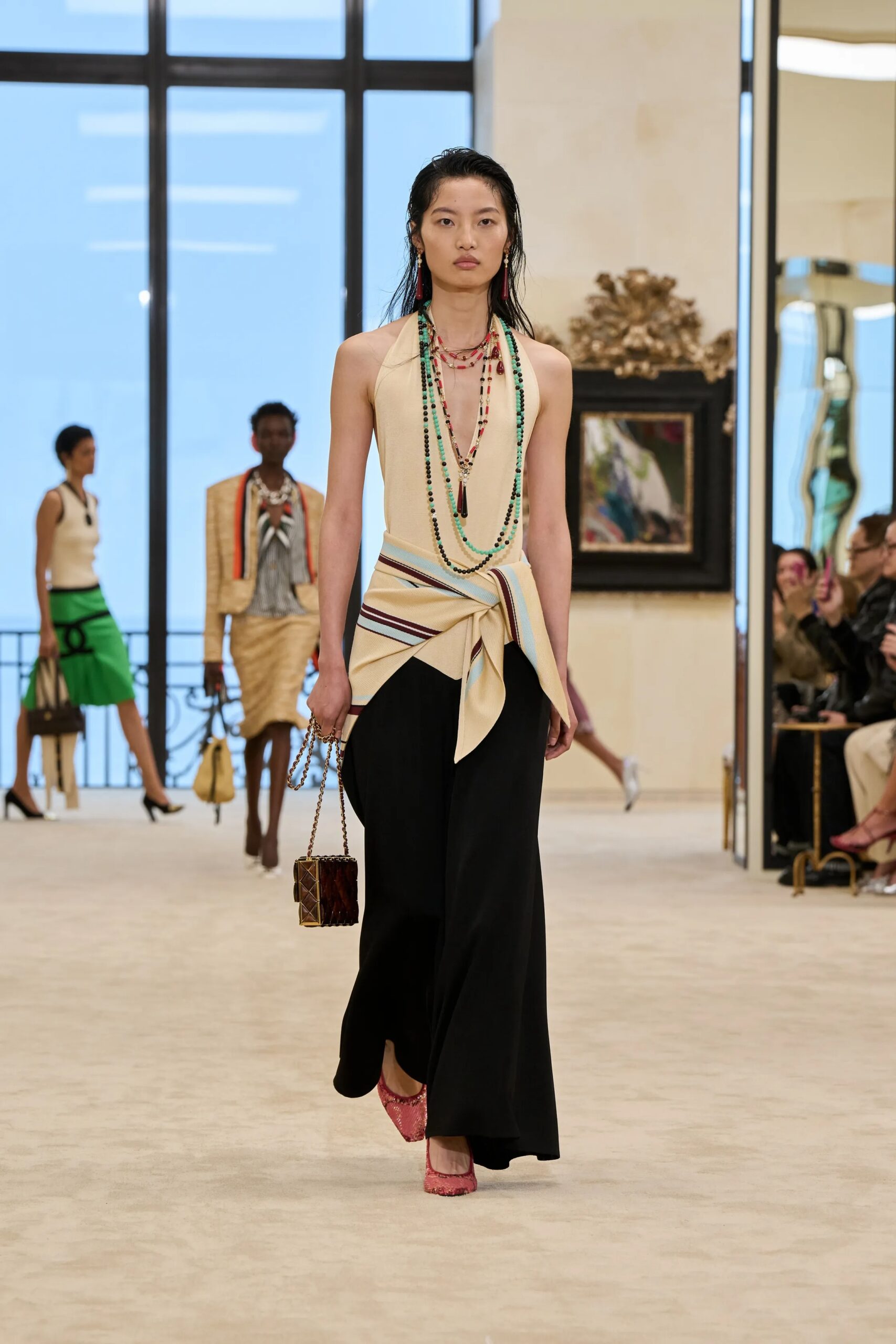 Chanel Cruise 2026/27 beige halter top black skirt layered necklaces runway look