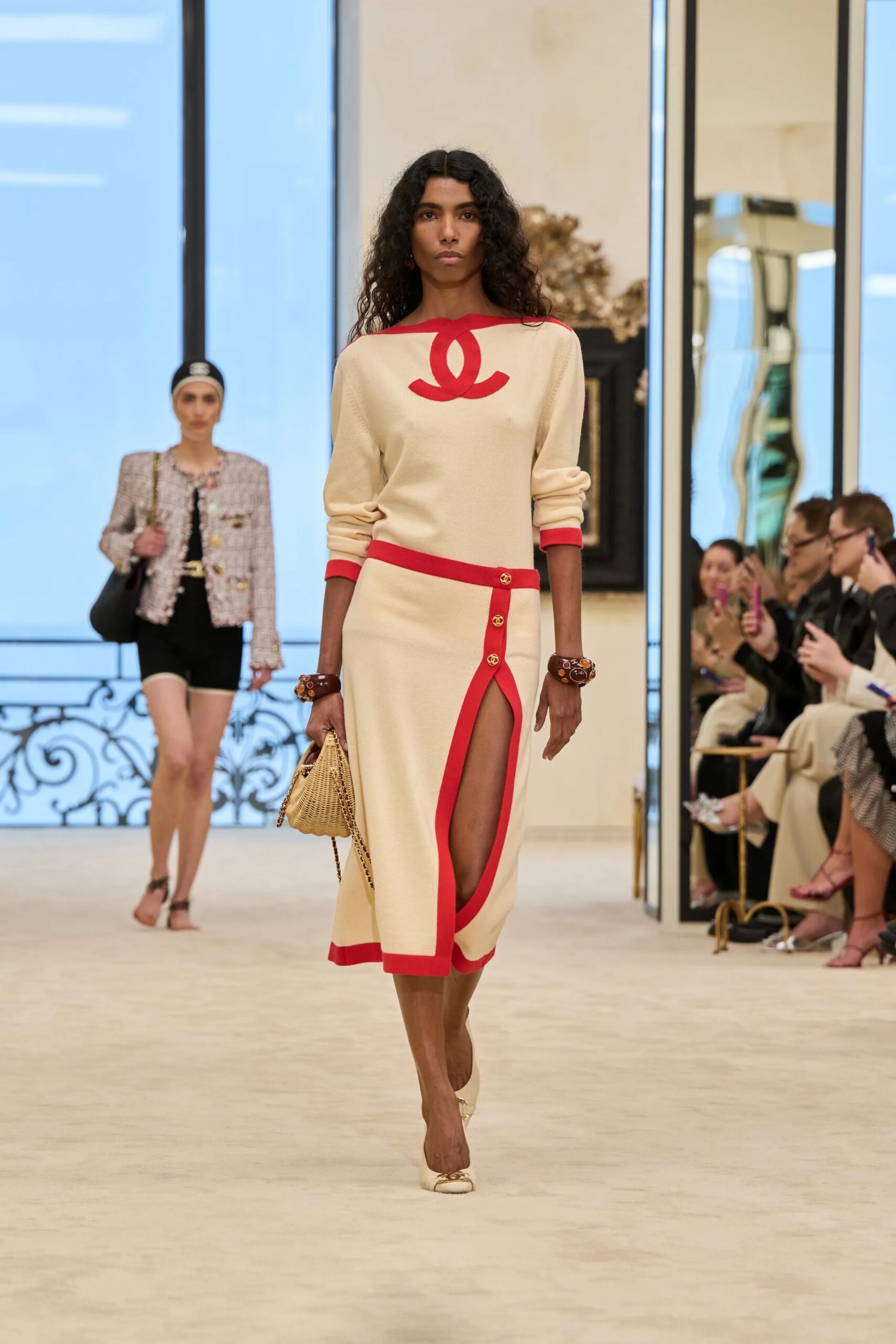 Chanel Cruise 2026/27 cream dress with red Chanel detail runway look