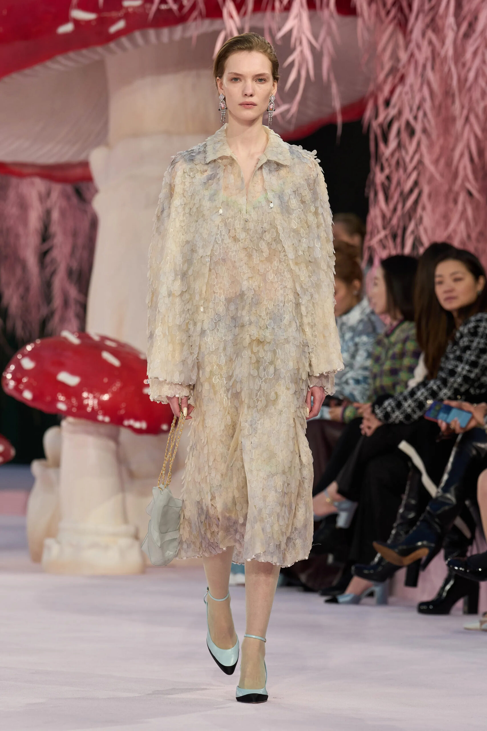 Model in shimmering ivory Chanel couture coat and dress with sequined texture and delicate embellishment