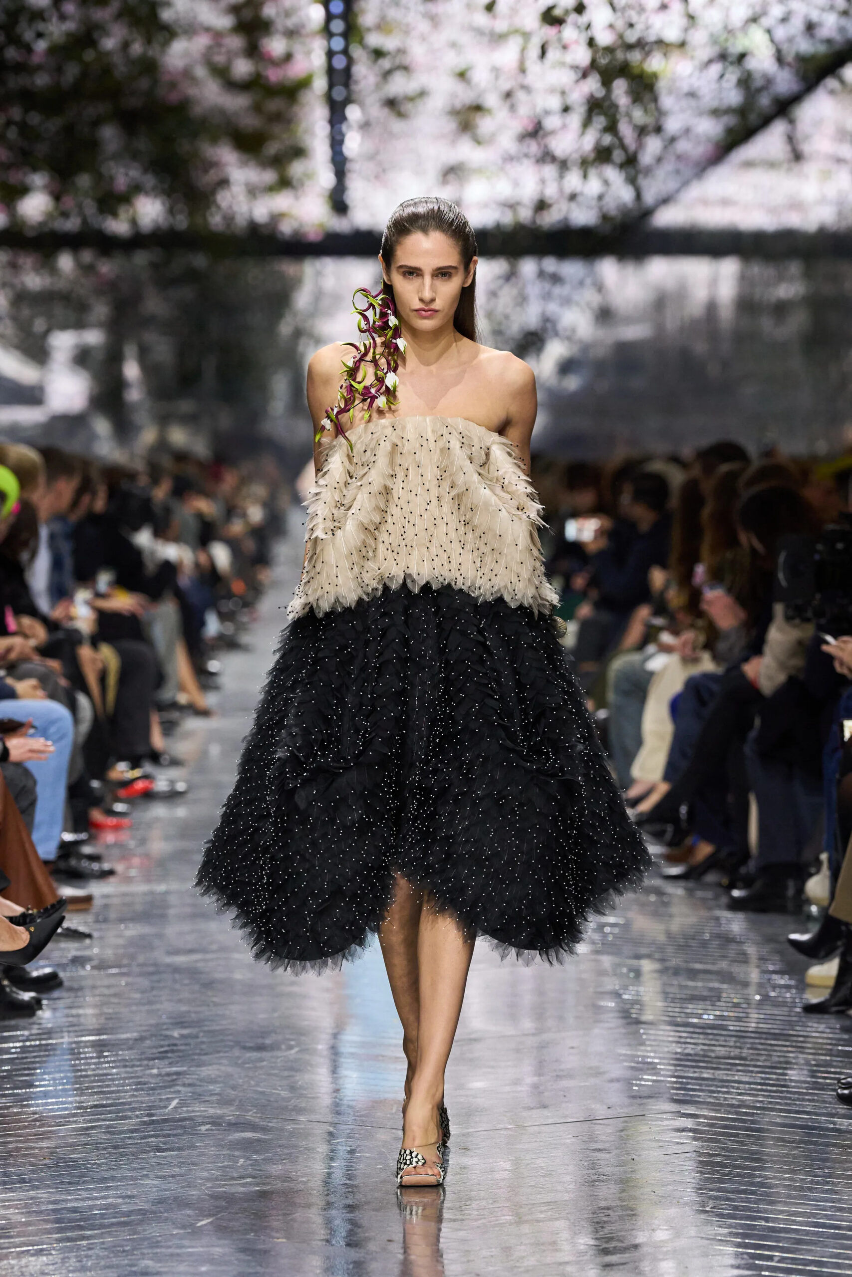 Model walking in Dior Spring 2026 Couture strapless ivory and black feathered dress with embellished detailing