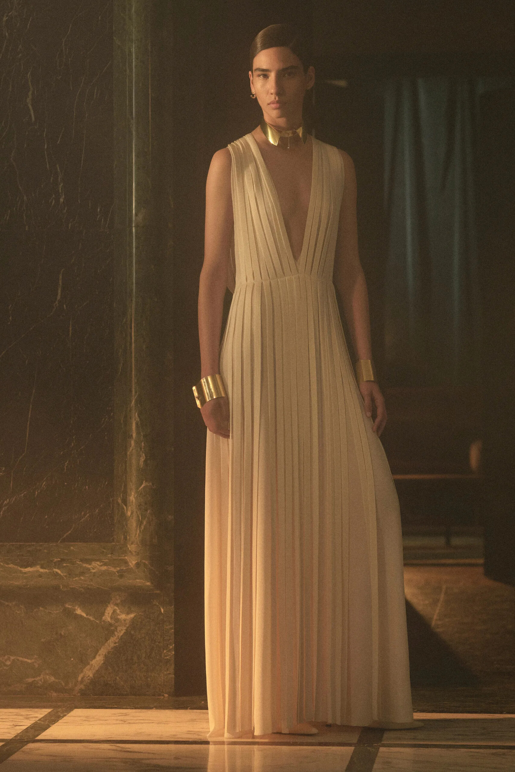 Ivory pleated plunging gown with sculptural gold jewelry from Fendi Resort 2027