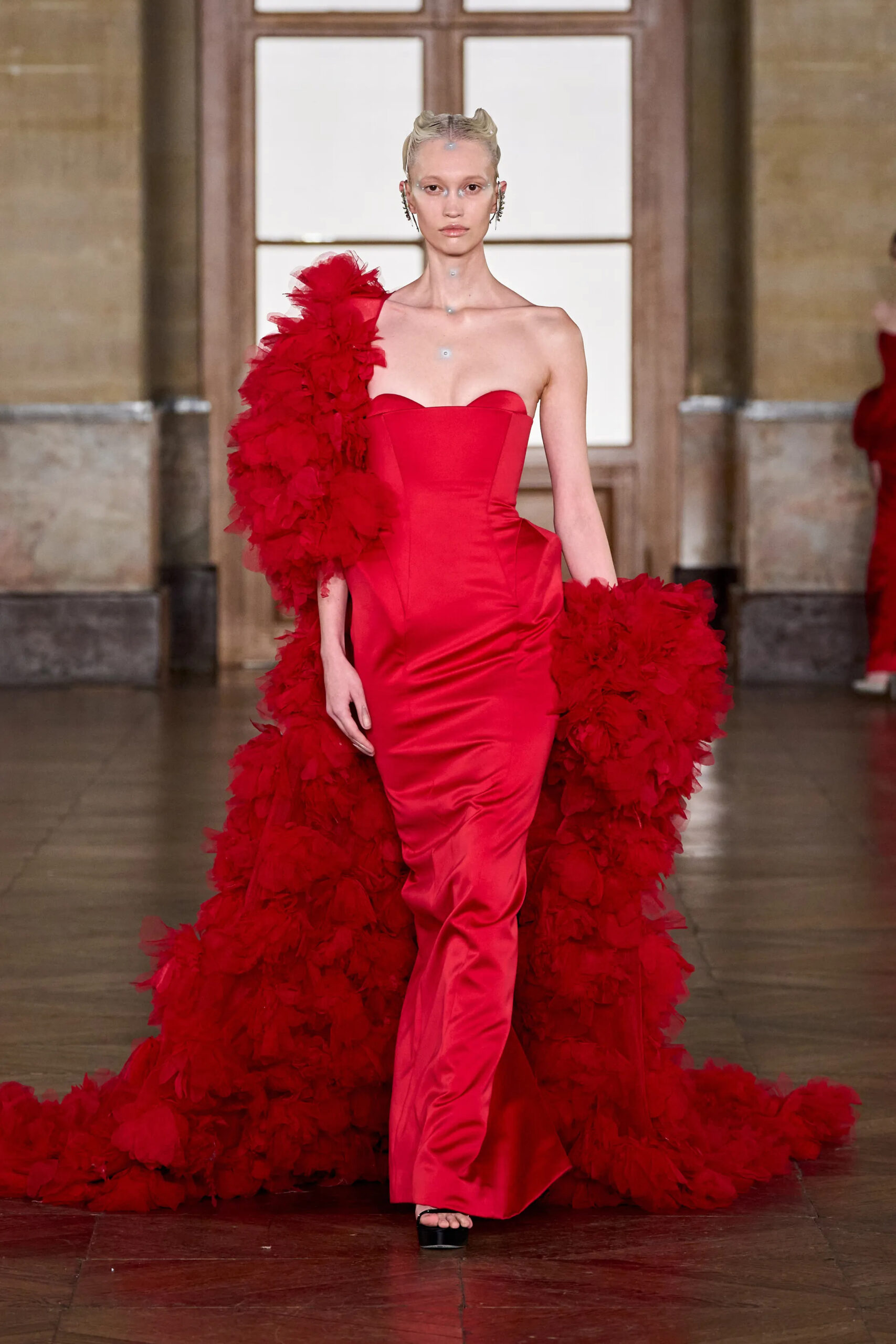 Red satin couture gown with dramatic feathered train by Gaurav Gupta Spring 2026 Couture