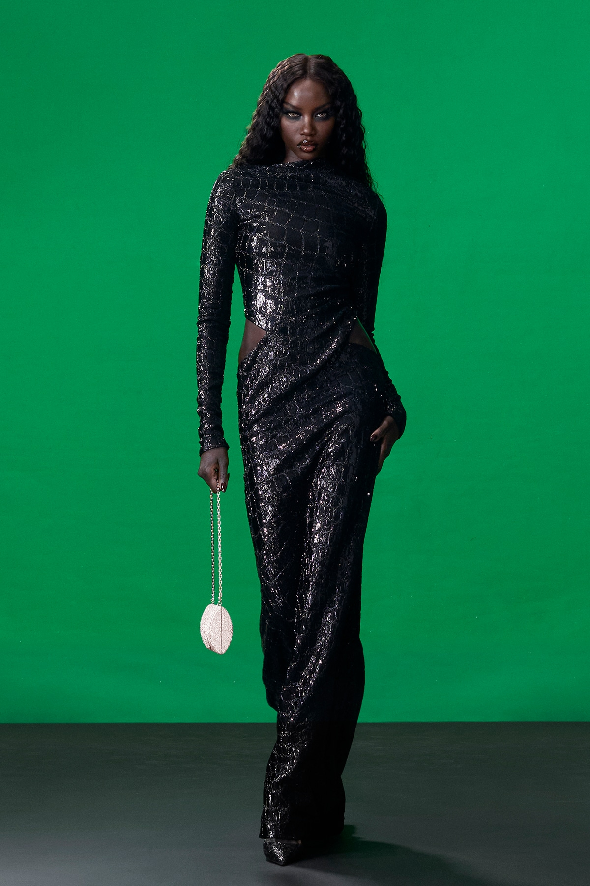 Model wearing black sequined Gucci evening gown during Gucci Resort 2027 runway show