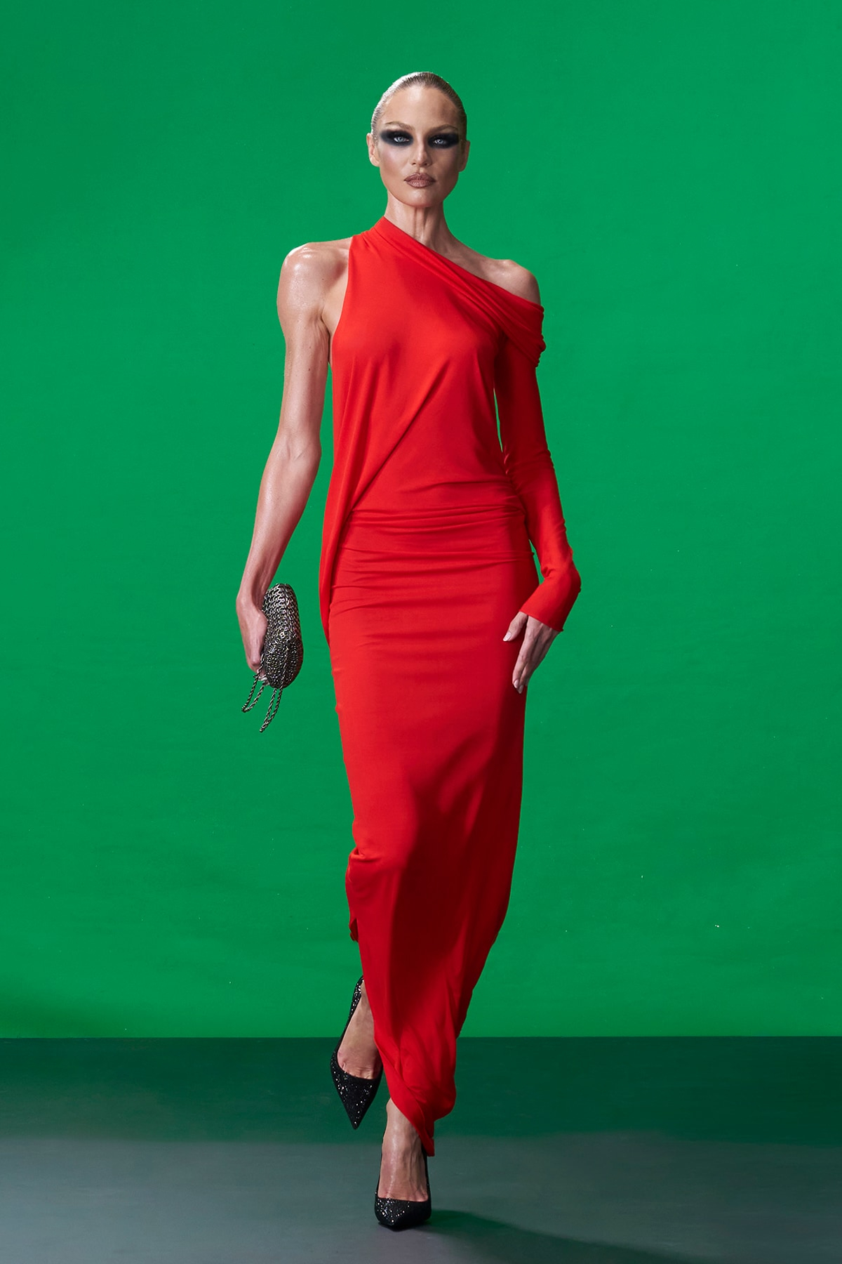 Model wearing asymmetrical red Gucci gown during Gucci Resort 2027 runway presentation