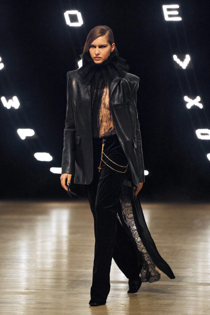 Model wearing a black leather blazer with lace details and velvet trousers at Khaite Fall Winter 2026 runway show
