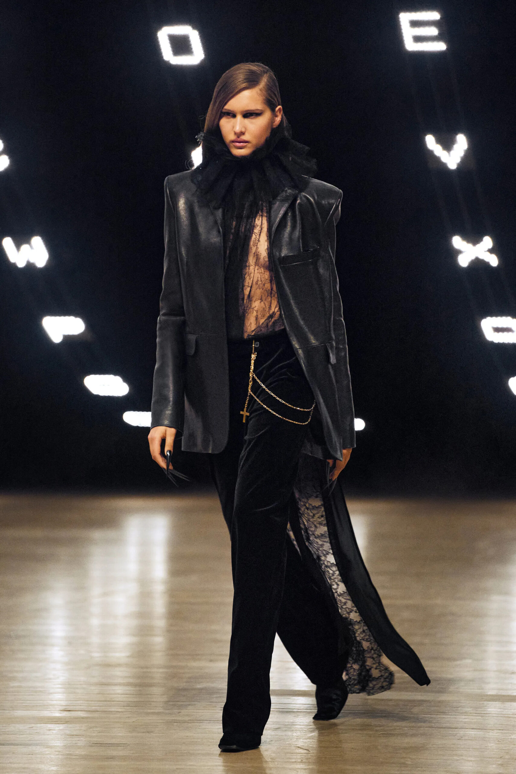 Model wearing a black leather blazer with lace details and velvet trousers at Khaite Fall Winter 2026 runway show