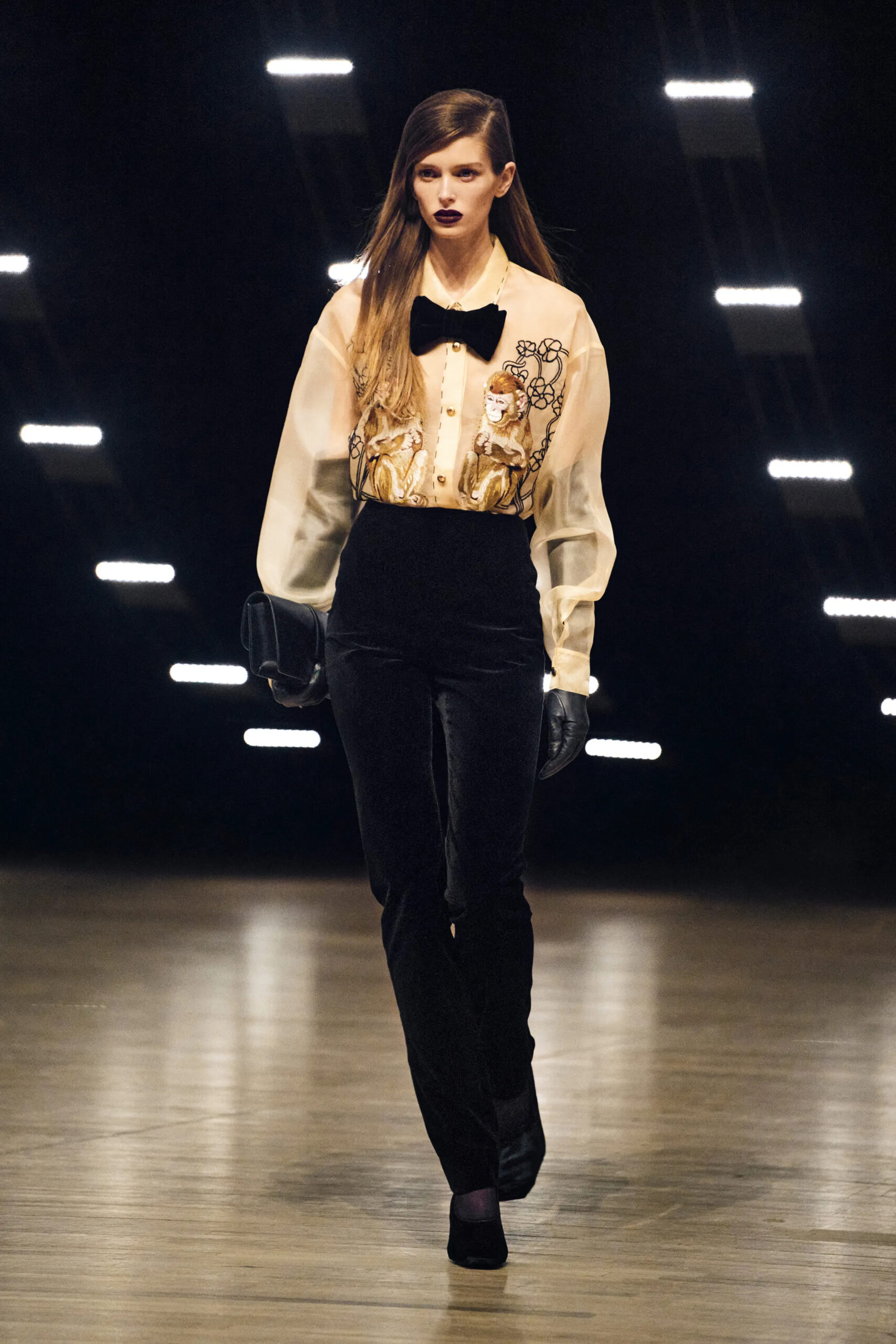 Model wearing an embroidered blouse with black velvet trousers at Khaite Fall Winter 2026 runway show
