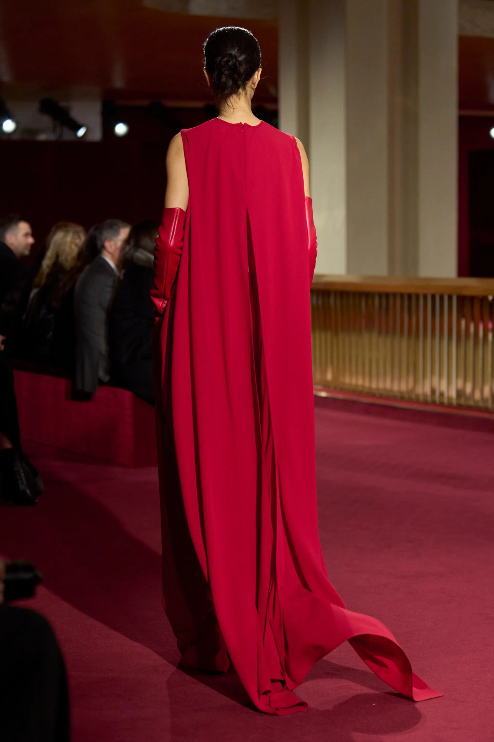 Back view of red flowing Michael Kors Collection gown during Fall Winter 2026 runway show