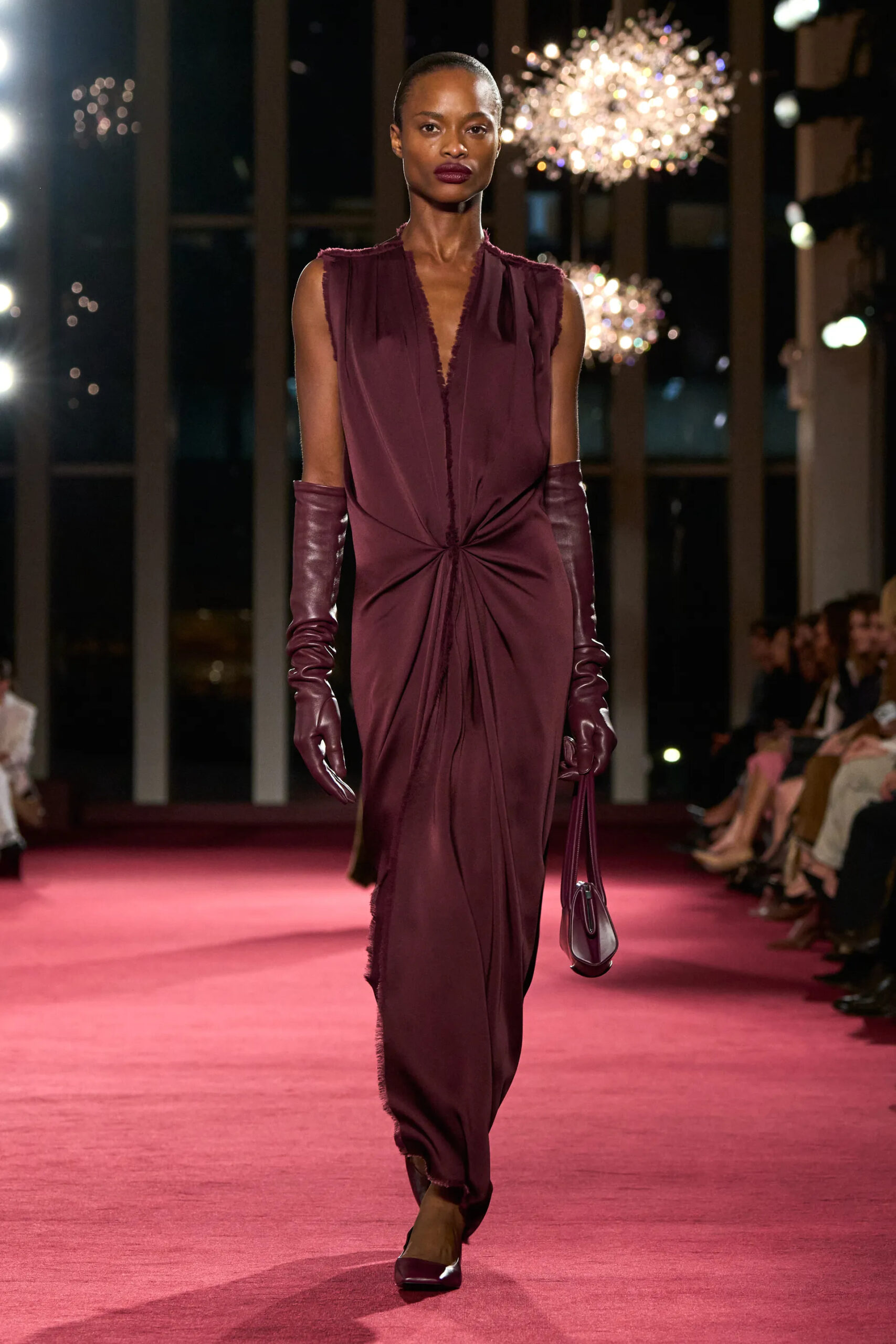 Michael Kors Collection burgundy draped gown with opera gloves at Fall Winter 2026 New York Fashion Week