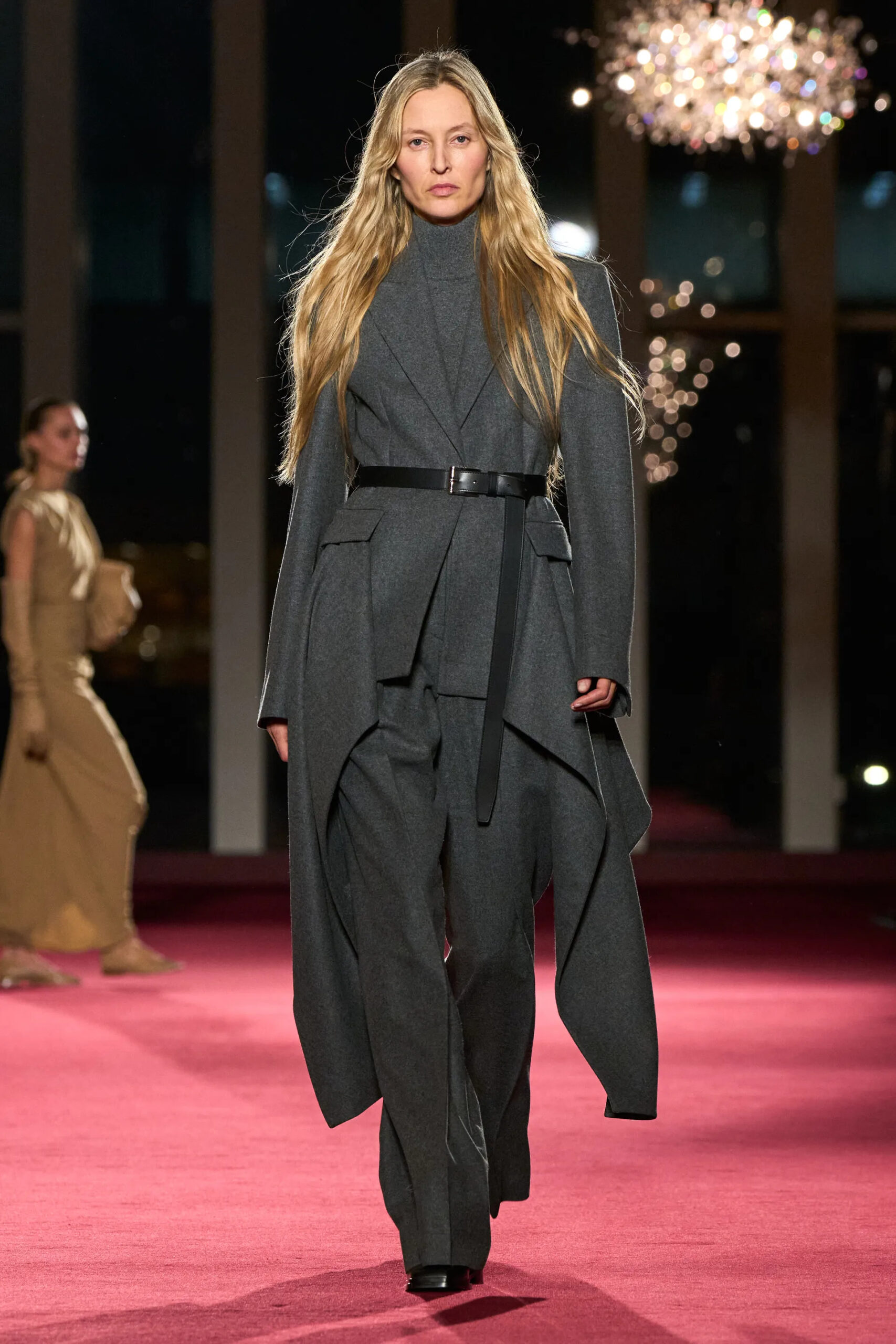 Michael Kors Collection charcoal layered tailoring with belt during Fall Winter 2026 runway show