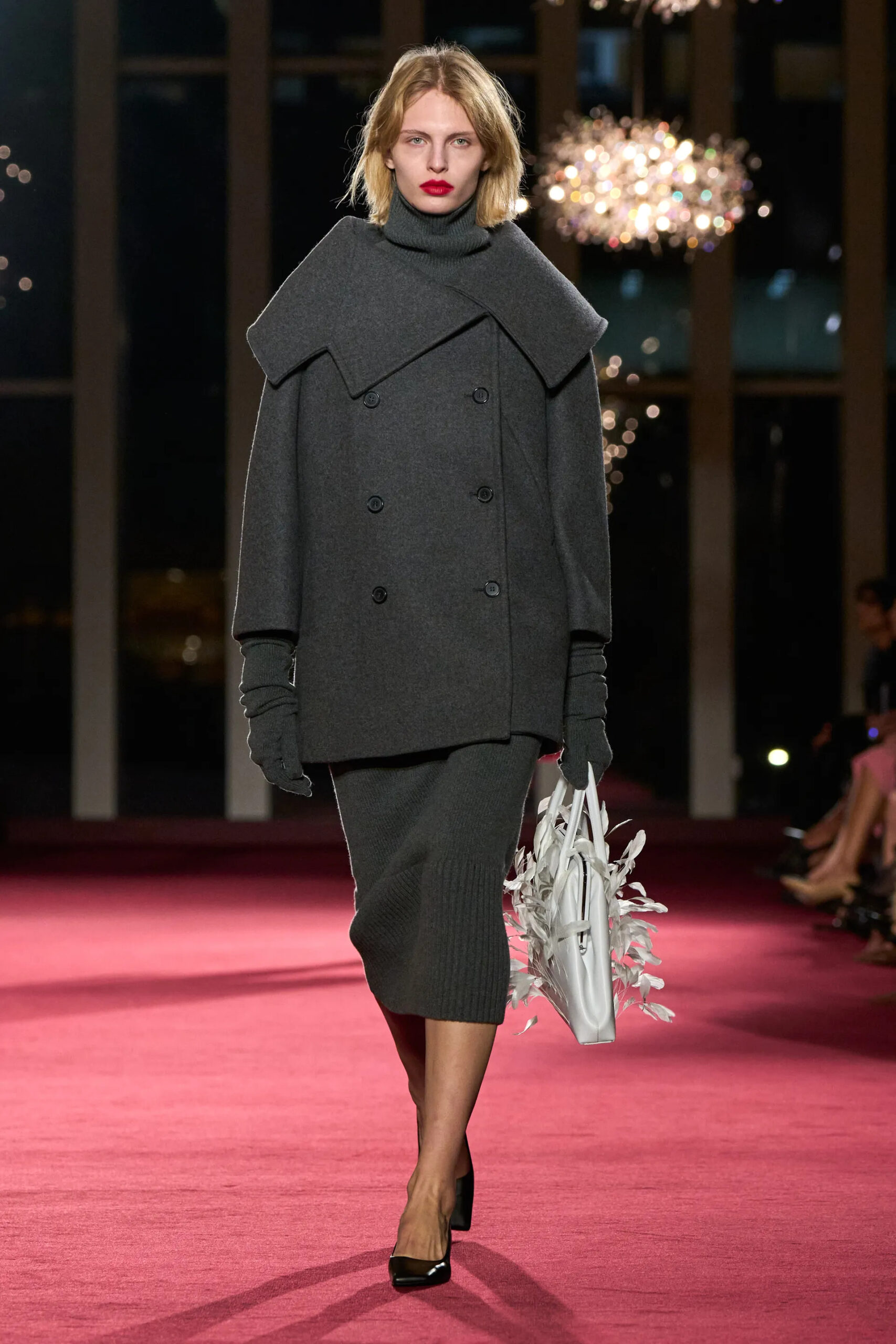 Michael Kors Collection grey knit runway look with floral handbag during New York Fashion Week