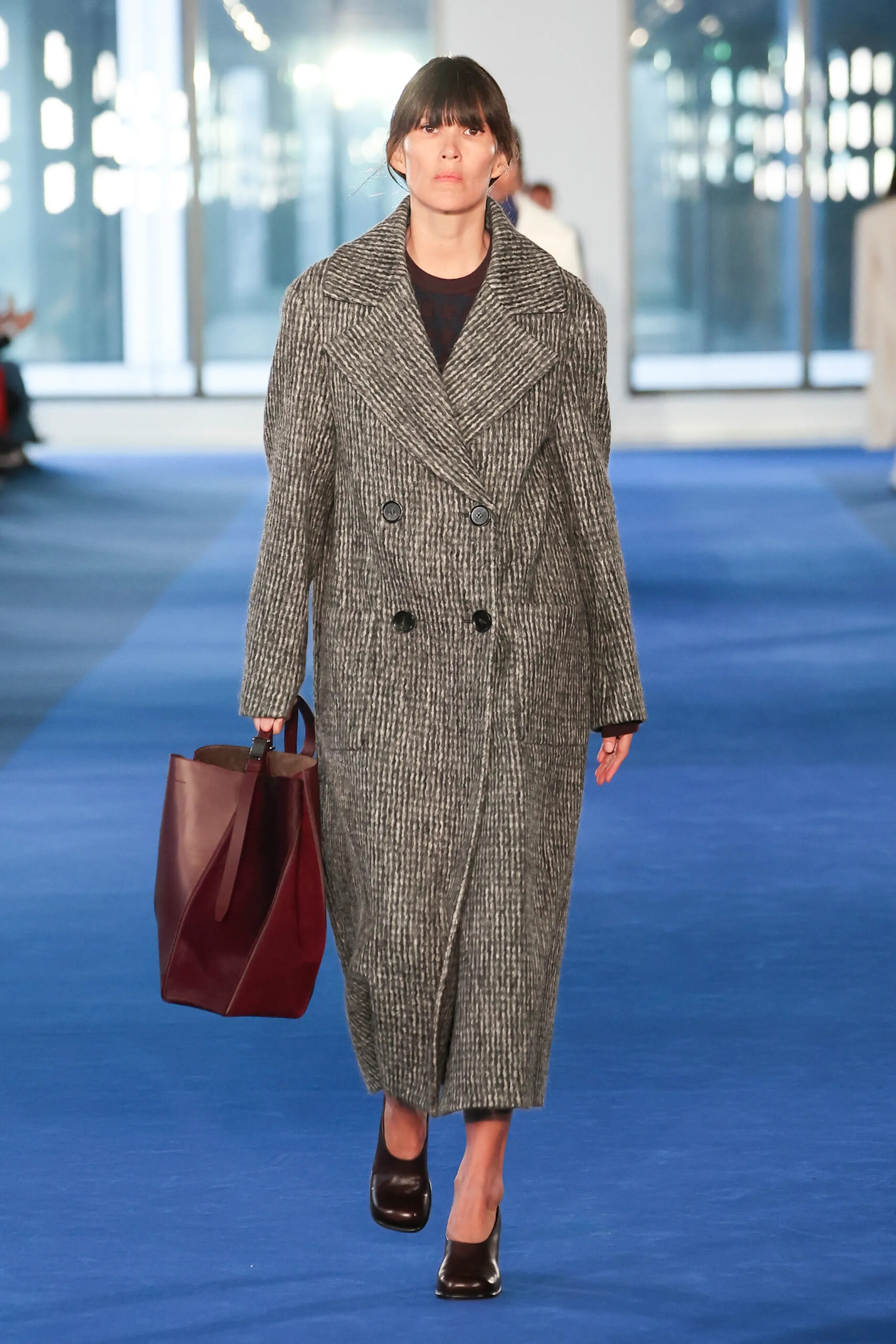 Charcoal textured coat with burgundy leather tote from Proenza Schouler Fall 2026