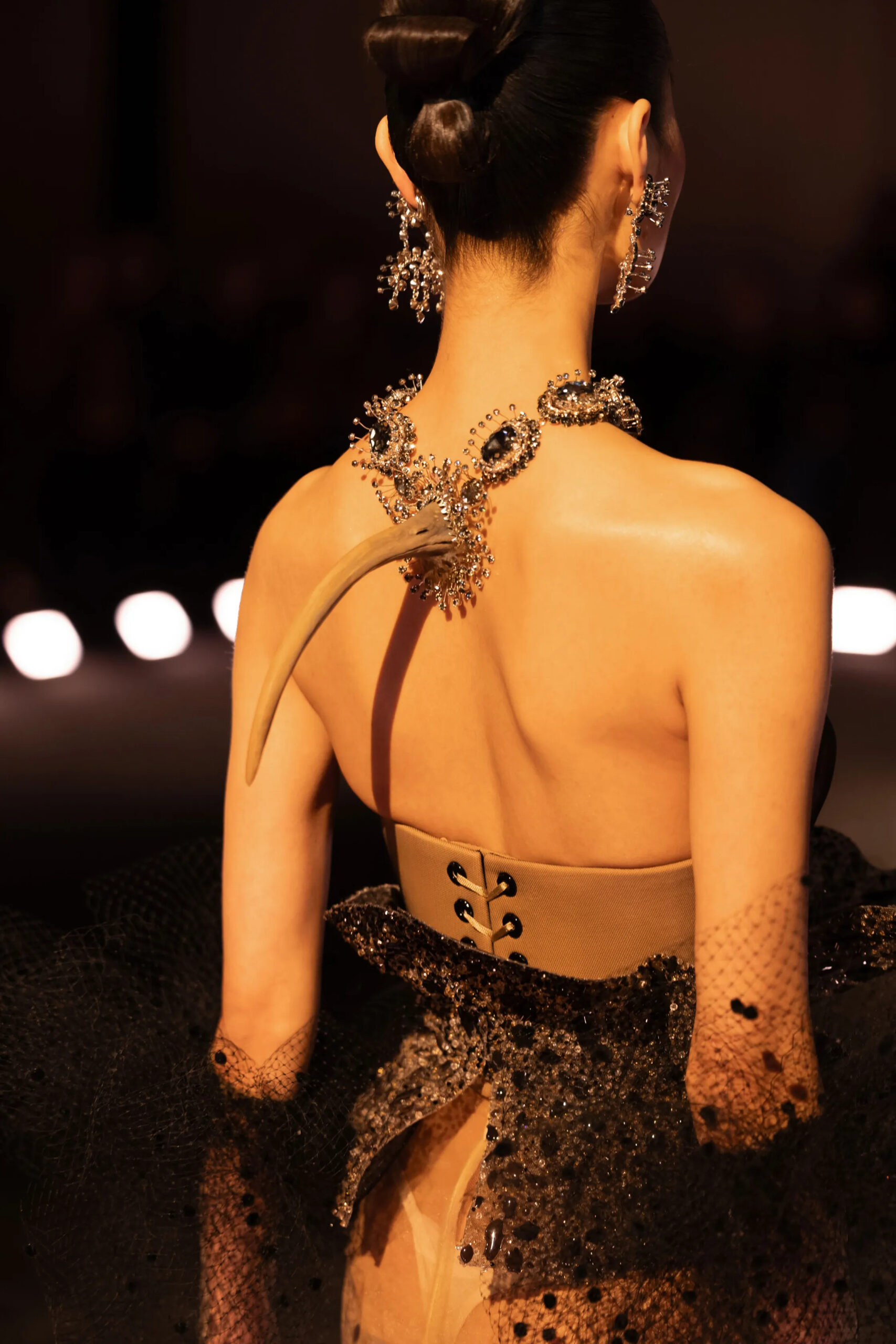 Back detail of Schiaparelli couture jewelry featuring sculptural bone-inspired necklace