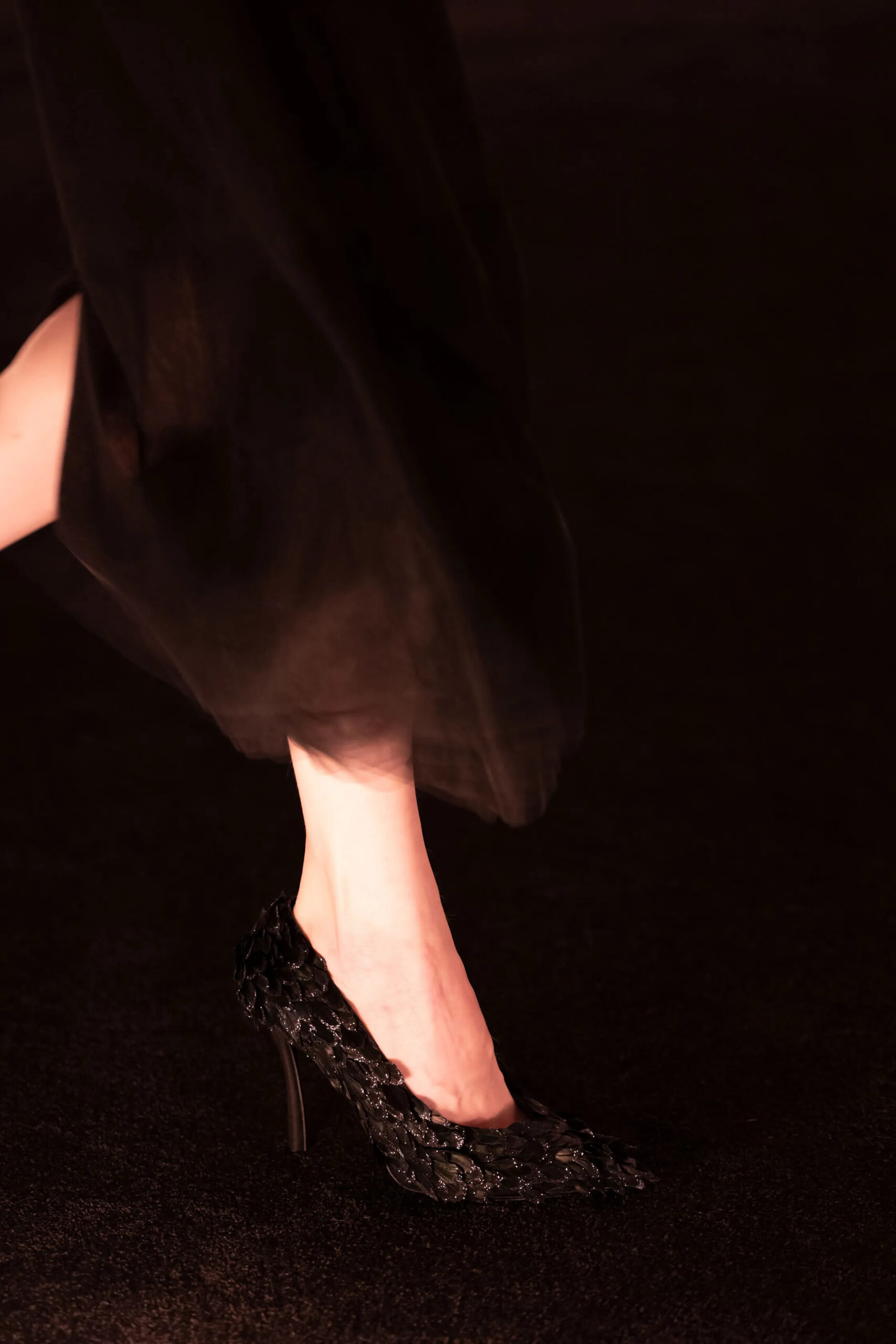 Close-up of black woven Schiaparelli couture heel