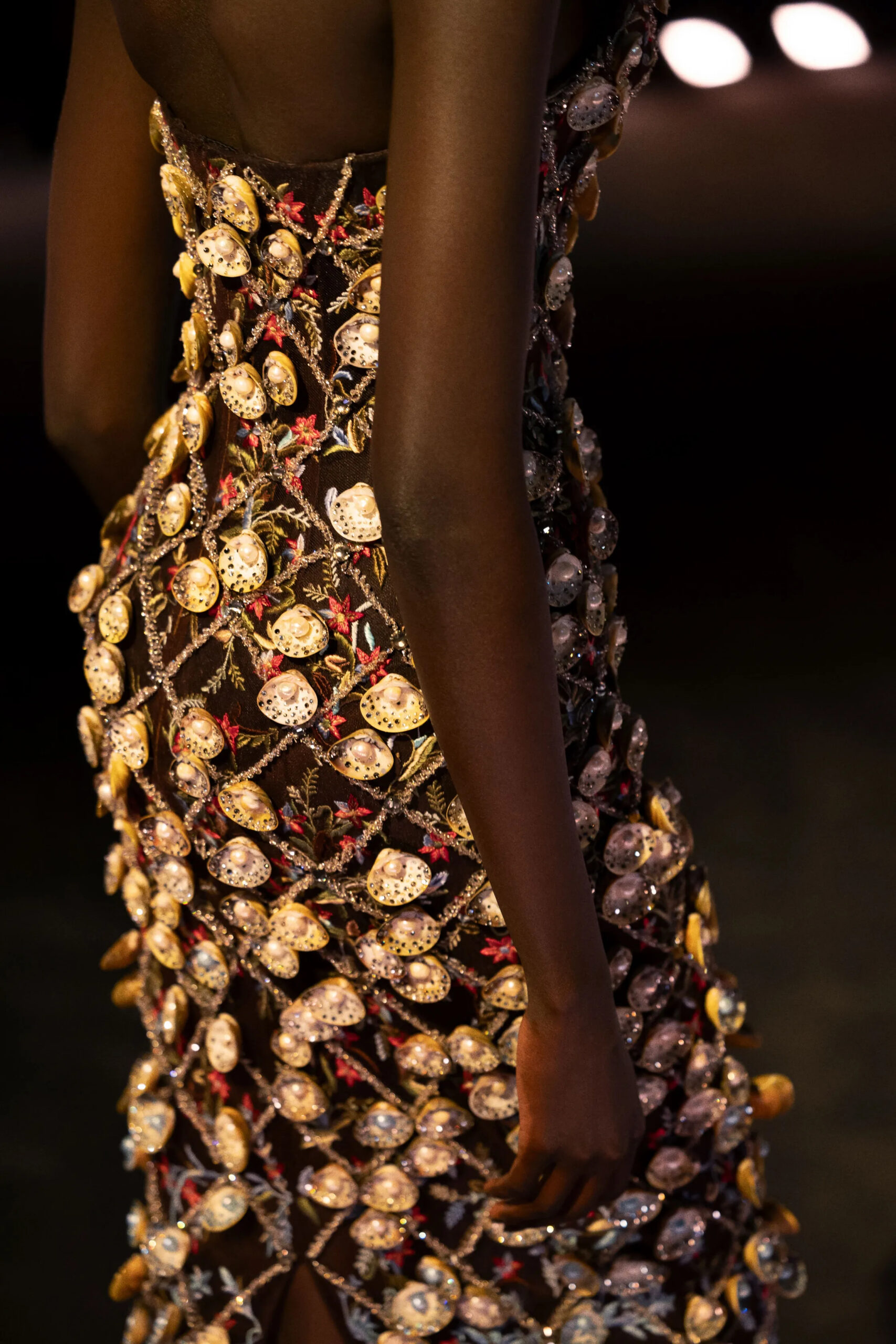 Detailed close-up of metallic coin embroidery on Schiaparelli couture dress